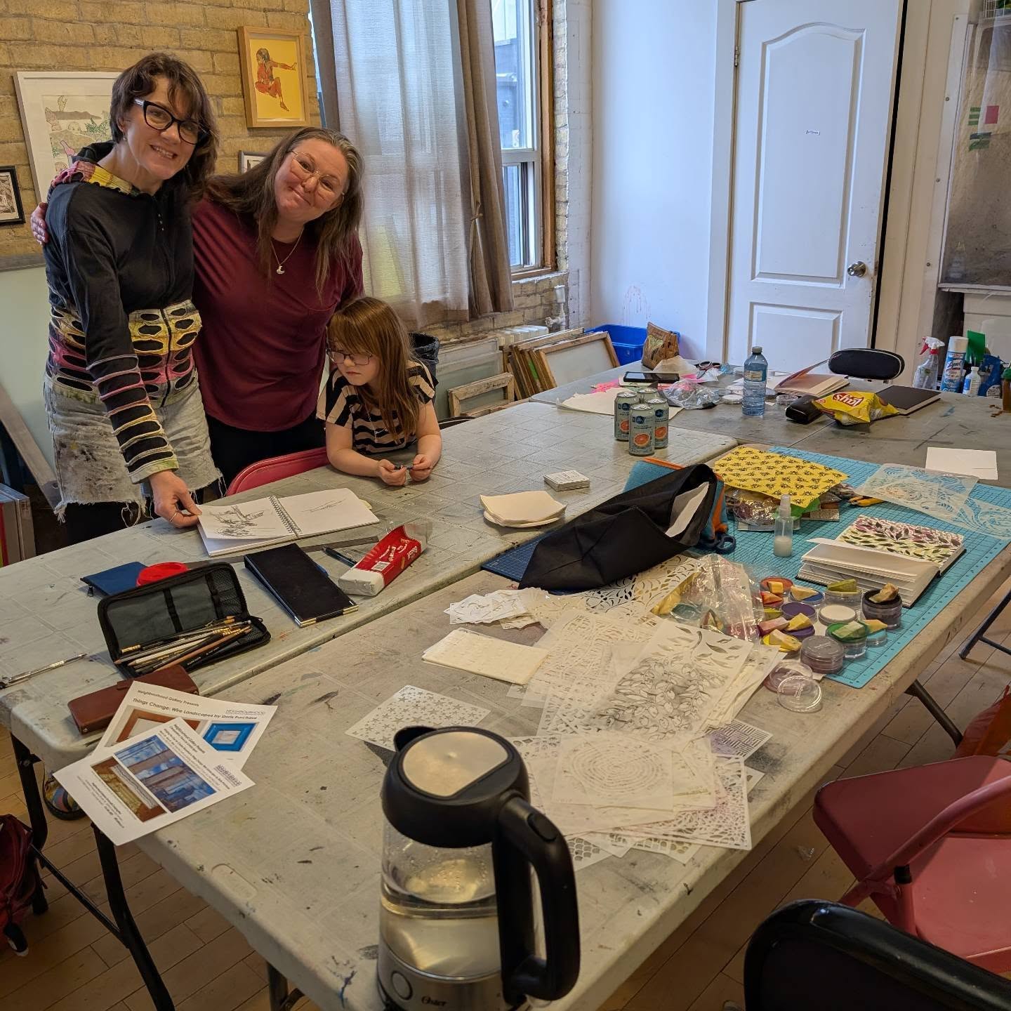 A fun day in the studio, working through sketches and ideas together! Today was our March drop-in and we thought it would be fun to have a sketchbook focus!
Don't forget - we host drop-ins every month AND we offer other options for renting time in the studio. Visit the link or www.inprintcollective.com/join-a-workshop and scroll to the bottom for more information.
Thanks to Doris and Scarlett for joining in our shenanigans today!
ID: a photo of two adults and a child standing over sketchbooks, which are on a messy worktable.