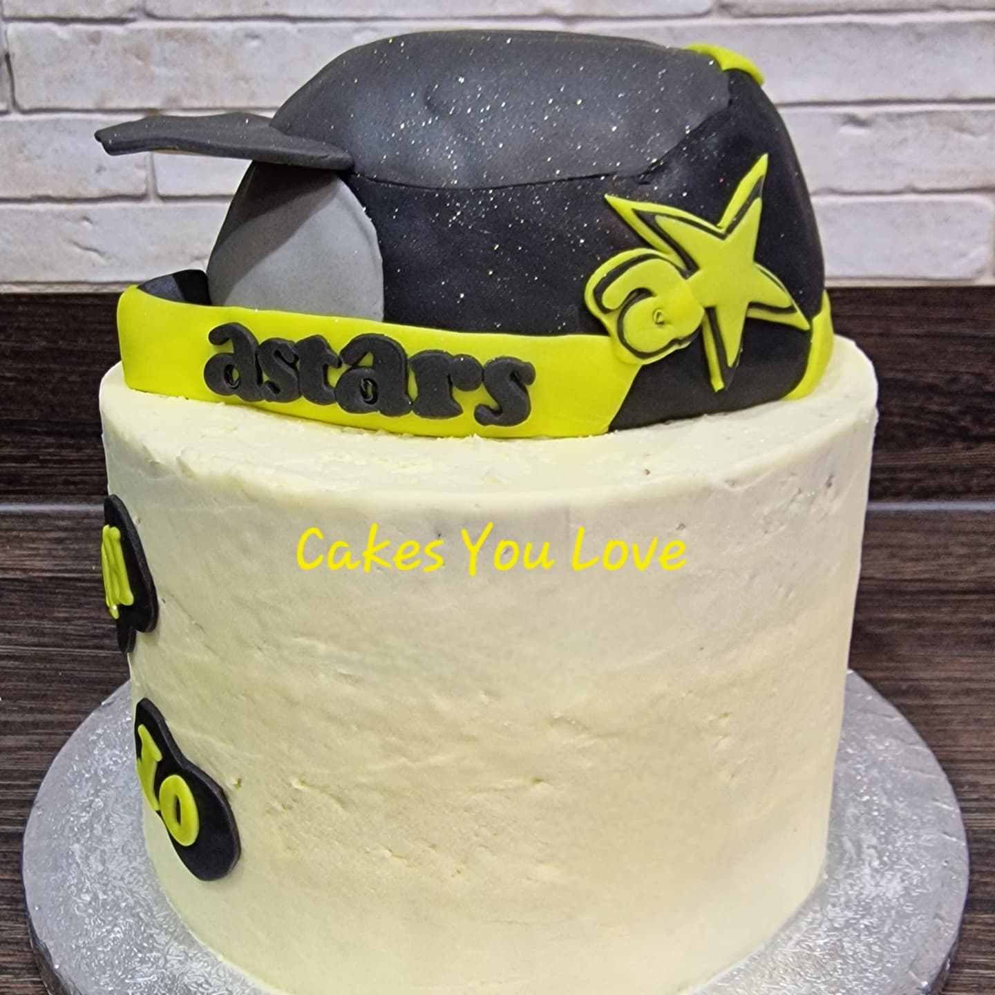 A vanilla sponge filled with vanilla buttercream. Motocross helmet handmade using rice krispie treats and fondant.