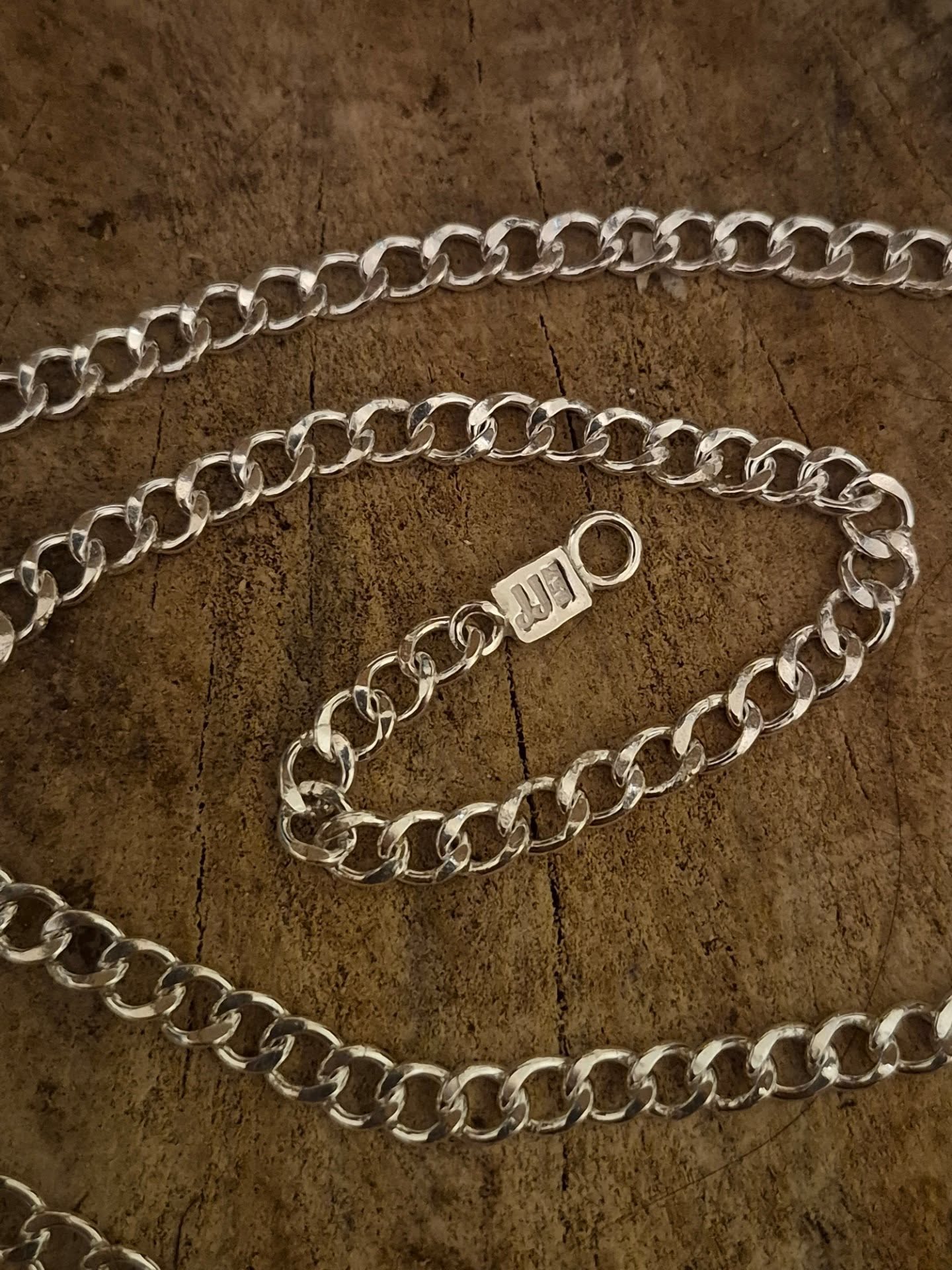 My first curb chain necklace ✨
The photos don’t do her justice! I was in a hurry to hand her over to her new owner. In real life, she’s even more beautiful.
I would say that I’m a pretty patient person but this piece really tested me.
I started by melting the silver, drawing it into wire, forming jumprings, and soldering them together (around 130 jumprings 😳), then twisting the chain to get that classic curb look.
After twisting, I flattened the chain with a rolling mill. But I didn't set it up correctly and accidentally flattened the chain way too much. There's no going back once the chain is too flat so I had to start all over again and make the necklace completely new.
Frustrating? Extremely. Worth it? 100%
In the end, I loved the necklace so much it was actually hard to let it go.
Still learning, still improving and still loving the process 🫶