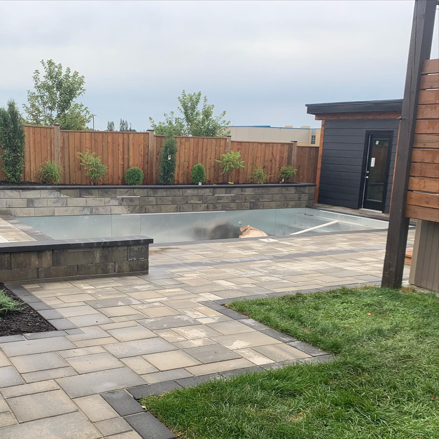 Couple shots of this backyard we have been working on, off and on for a couple weeks because of supply issues. But it is almost there! We’ll post some better pics once it’s all complete, it really is a beauty. @toctbay @techobloc @lockstoneyardandpatio #summeroasis#backyardtransformation#poolpartysoon#timberframepoolhouse#beforeandafter#