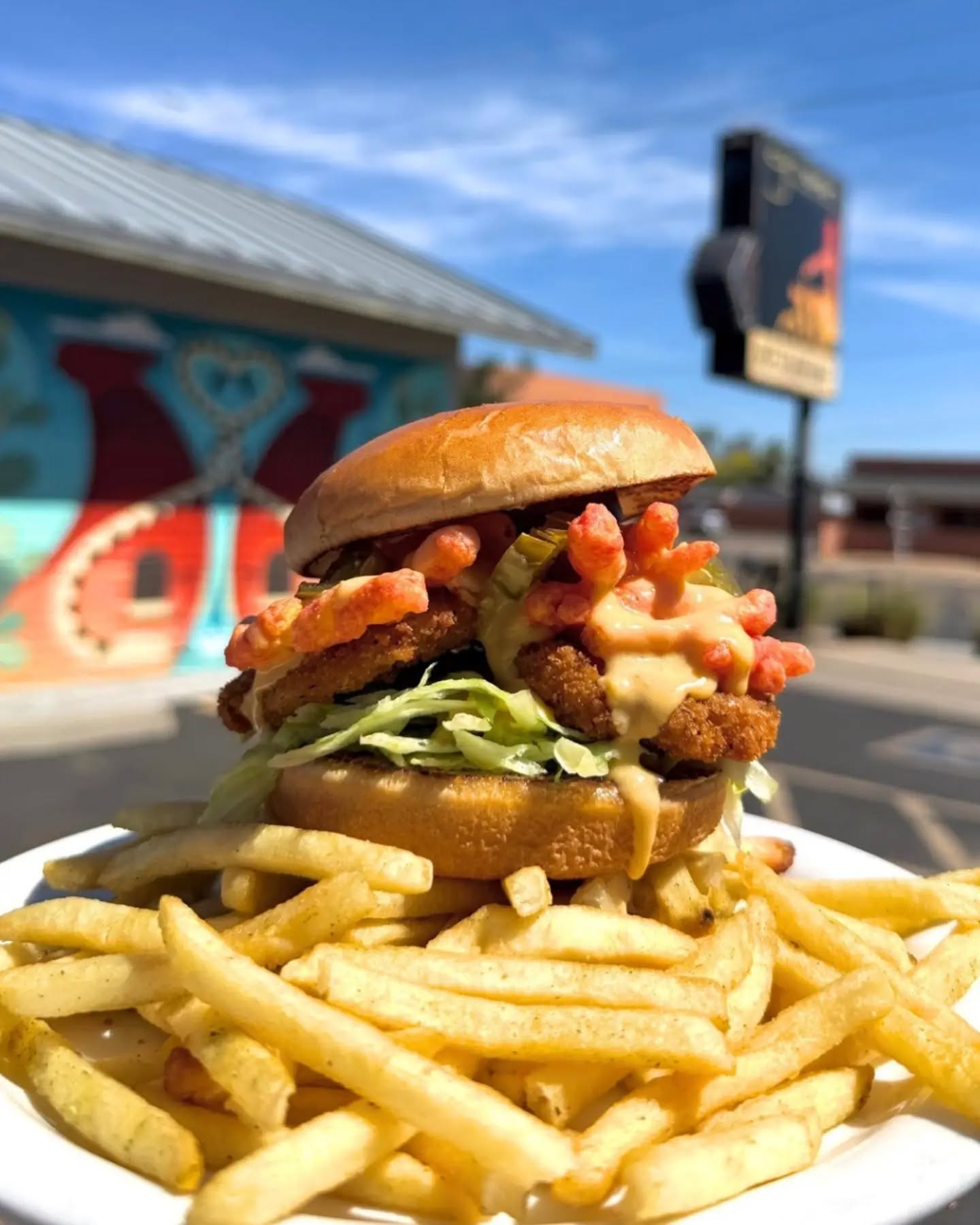 FLAMING HOT FOWL
Now at #greenPhx
Our house crispy fried chick’n stacked with shredded lettuce, crushed flaming hot @takisusa Pips for that electric crunch, melty EZ cheese, and a reckless hit of pickled jalapeños atop a mountain of thyme fries.
#alwaysvegan #veganhotcheetos #iykyk #takispips
