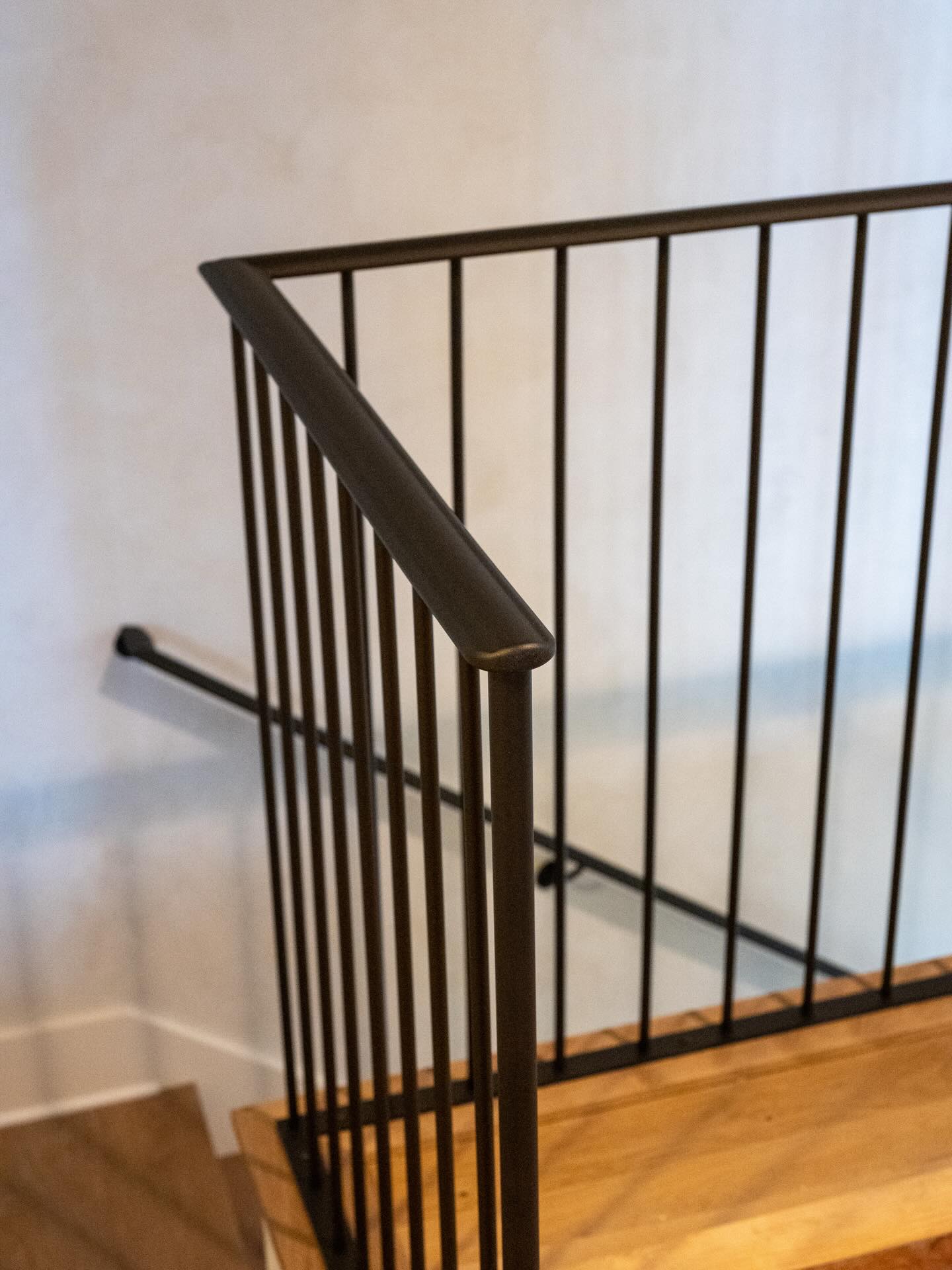 A minimalist rail with a few special details. No visible welds, forged top rail, and hidden spacers at the walls to allow for perfect fitment.