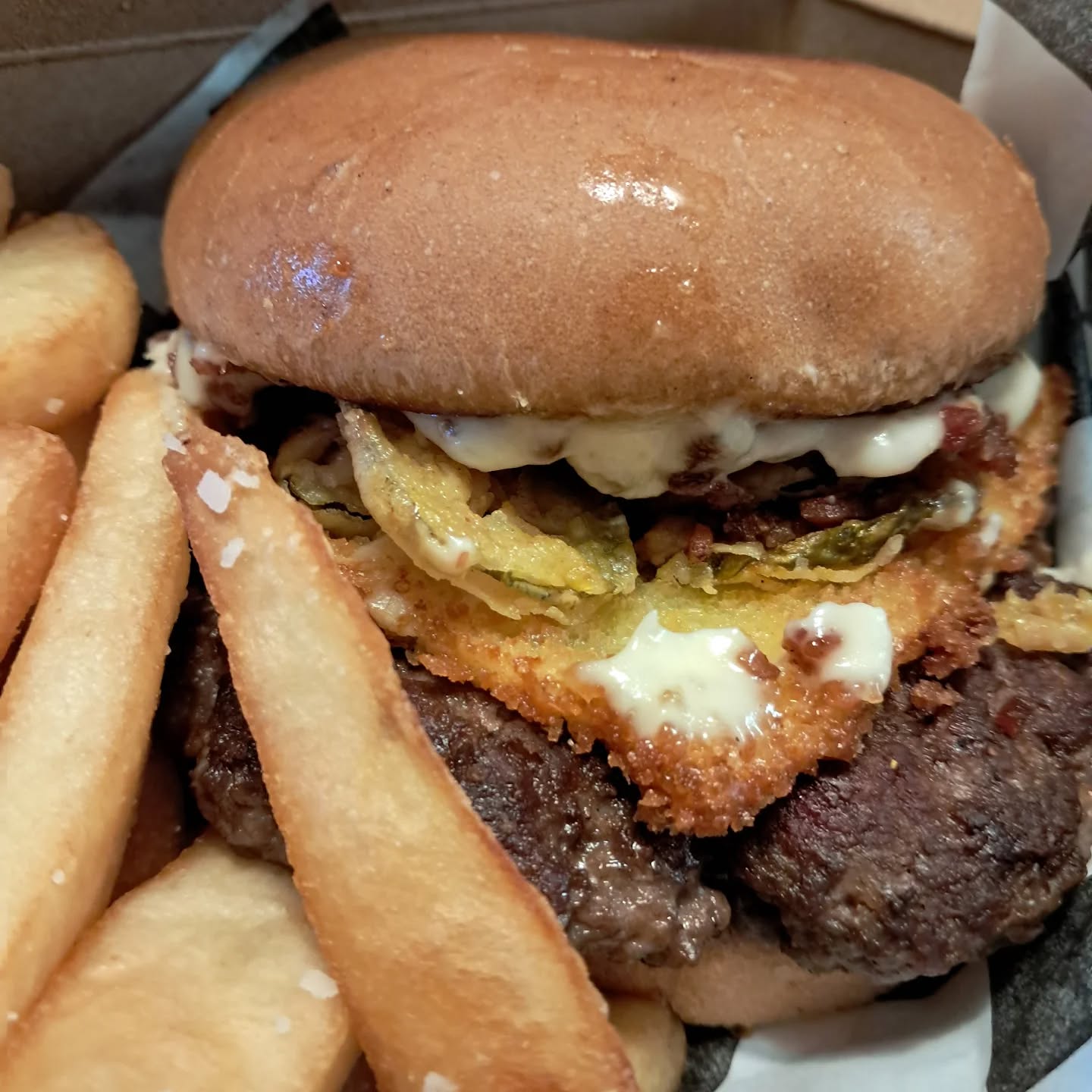 Burger innovation at @crunchfactoromaha The Crunch Deluxe has a short rib patty with sharp cheddar, minced bacon, lightly fried sliced american cheese, carmelized onion aioli, and fried pickles.
This was a delicious burger 🍔 with an adventure of flavor pops as you travel through this hand-held as you hit a fried pickle or a bacon nibble. The lightly fried single slice of American cheese was a new concept to me and a fun idea. Keep an eye on the rotating menu and find them at @lovelybrewingcompany
Happy Faturday and remember to Connect With Food!
