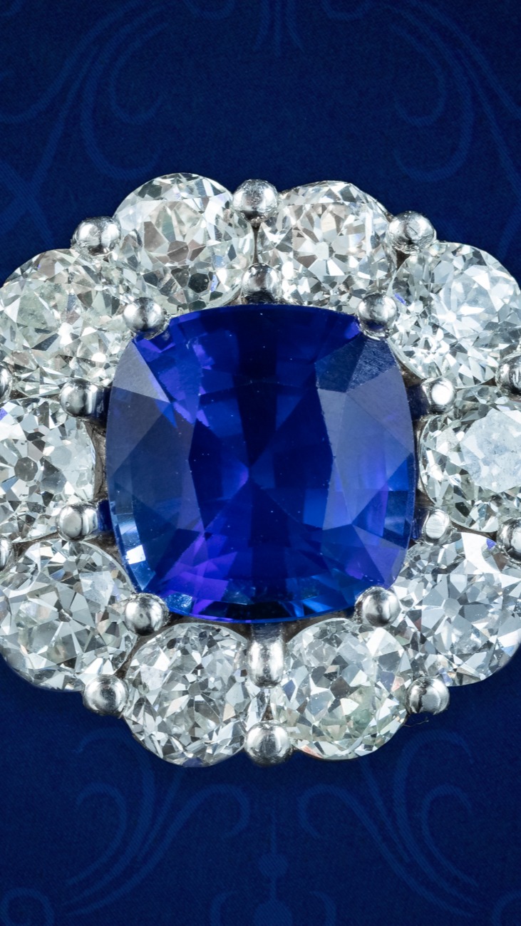 Edwardian Style Sapphire Diamond Cluster Ring 2.42ct Natural Sapphire
Radiating a regal blue beauty, this stunning Edwardian-inspired sapphire diamond cluster ring is sure to catch the eye! A natural deep-blue cushion cut sapphire is claw set at its heart, weighing 2.42 carats, contrasted against a sparkling frame of ten chunky old European cut diamonds, with two smaller diamonds twinkling on each shoulder. They all have excellent SI1 clarity – H colour and the larger stones weigh approx. 0.22ct each, bringing the total to 2.35 carats.
Sapphire is considered a stone of wisdom, loyalty, and protection and has long been a favourite of kings and royalty. Its regal, deep-blue colouring contrasts beautifully with the brilliance of diamonds, together embodying beauty, strength and eternal love, making them the perfect choice for an engagement ring.
Go to www.houseofstyleanddesign.com to find out more details about this spectacular ring. Item No. MK15.
#sapphire #diamond #ring