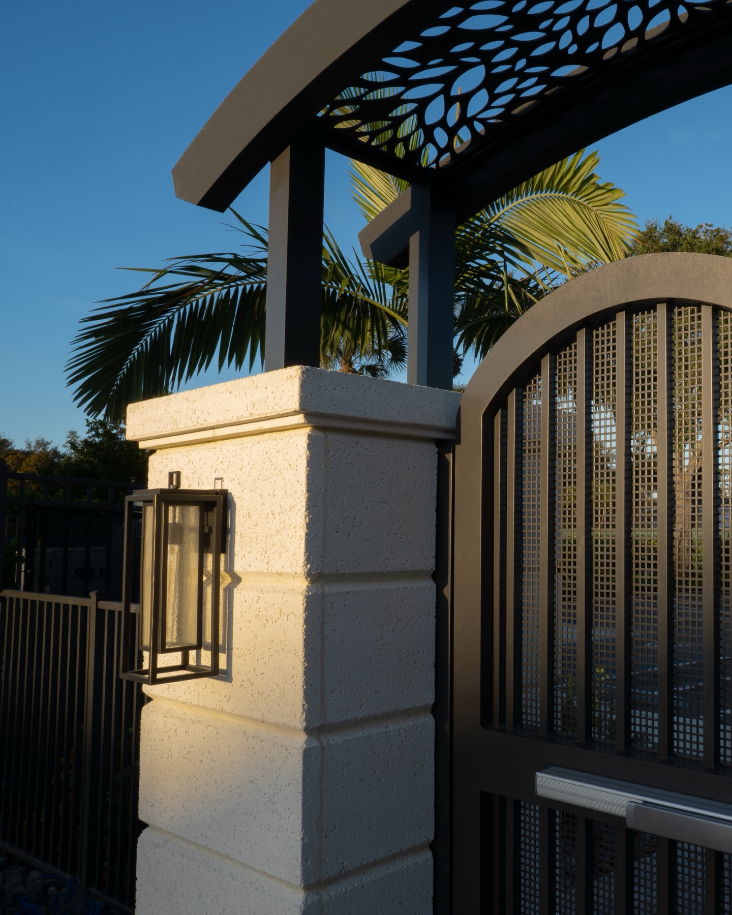 Precision metalwork. Layered architecture. A gated arrival that quietly sets the tone. ✨
At the pool house entrance for Kensington Golf & Country Club, the custom arched gate is framed by intricate laser-cut metal detailing above turning a simple threshold into a designed moment. The layered textures, soft stucco, and sculptural lighting create a refined transition from clubhouse energy to private poolside retreat.
It’s the small architectural gestures that elevate the entire experience.
#KensingtonGolfandCountryClub #LuxuryLandscapeArchitecture #CountryClubDesign #NaplesFloridaDesign #ArchitecturalDetails