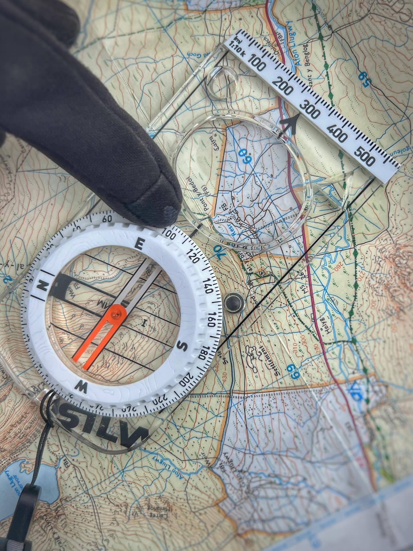 “I think my compass is broken!”
“No it’s not! I reply
There is a chance it is. Could have lost its fluid, could have flipped N to S, could have been stood on.
As we’re running through bearings on Mountain Leader training day 1 when people could well be inexperienced and / or rusty, experience tells me that it’s more likely user error.
That is no problem at all, in fact, it’s to be expected!
Usually it’s been lined up incorrectly or something and honestly it’s something to learn from because MLs will be teaching others and it’s good to know common mistakes.
ML training is just that. Training. No assessment, no judging you for your mistakes, just a nice week in the hills sharing some knowledge.
It wasn’t this compass today, this is an orienteering one used by one of the trainees. It settles faster and is really clear, shame no 1:25/40/50 scales though.
.
#navigation #map #compass #mountains