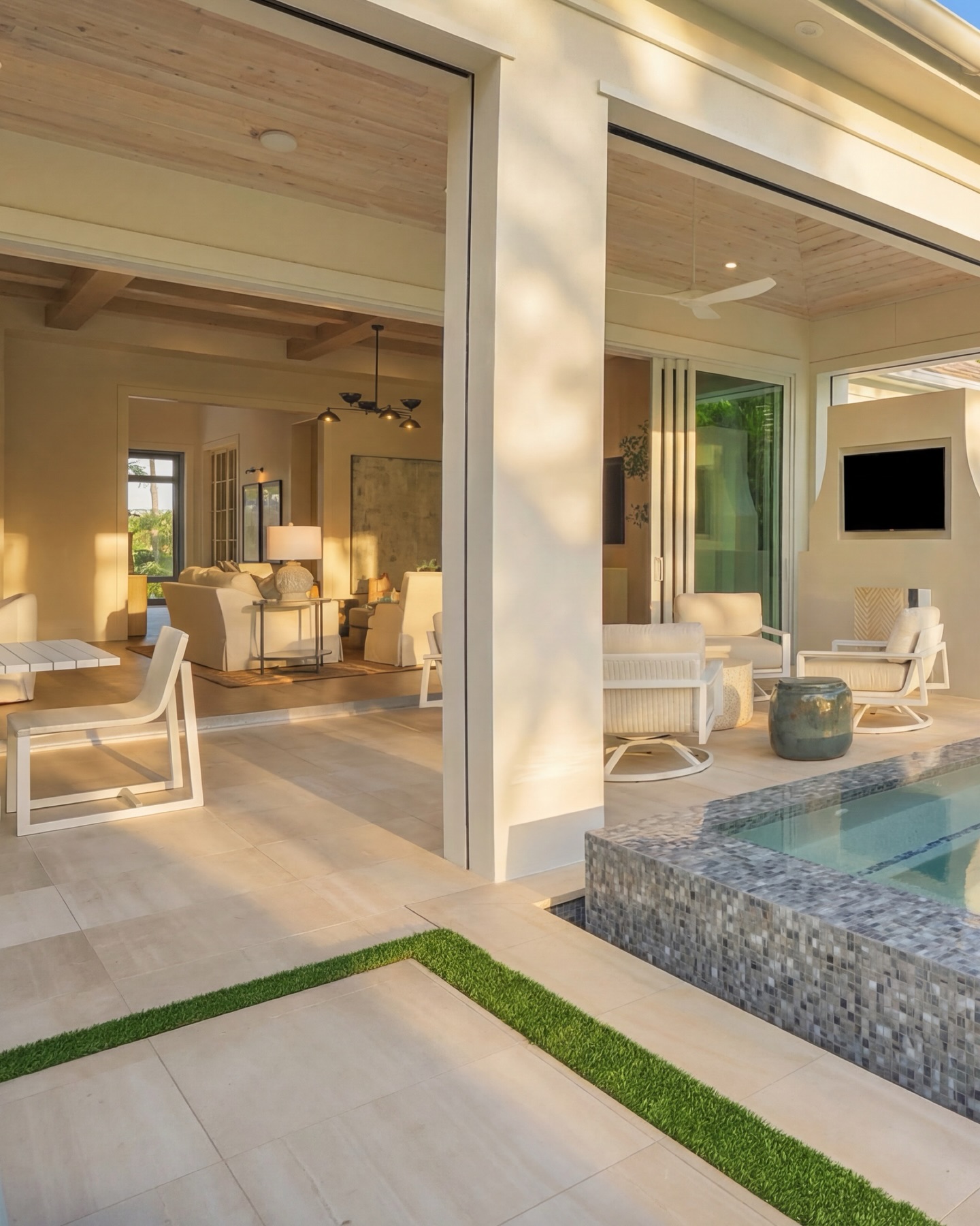 Park Shore luxury outdoor living, designed for seamless indoor-outdoor flow. This custom Naples pool design features a raised tiled spa, linear water wall with scuppers, and a modern two-way fireplace anchoring the covered lounge. Large-format pavers with a clean turf border define the pool deck, creating a refined, low-maintenance outdoor space tailored for Florida coastal living. A layered privacy hedge, resort-style pool, and architectural details bring elevated backyard design to Park Shore.
#NaplesFLHomes #LuxuryOutdoorLiving #ParkShoreNaples #CustomPoolDesign #FloridaLiving