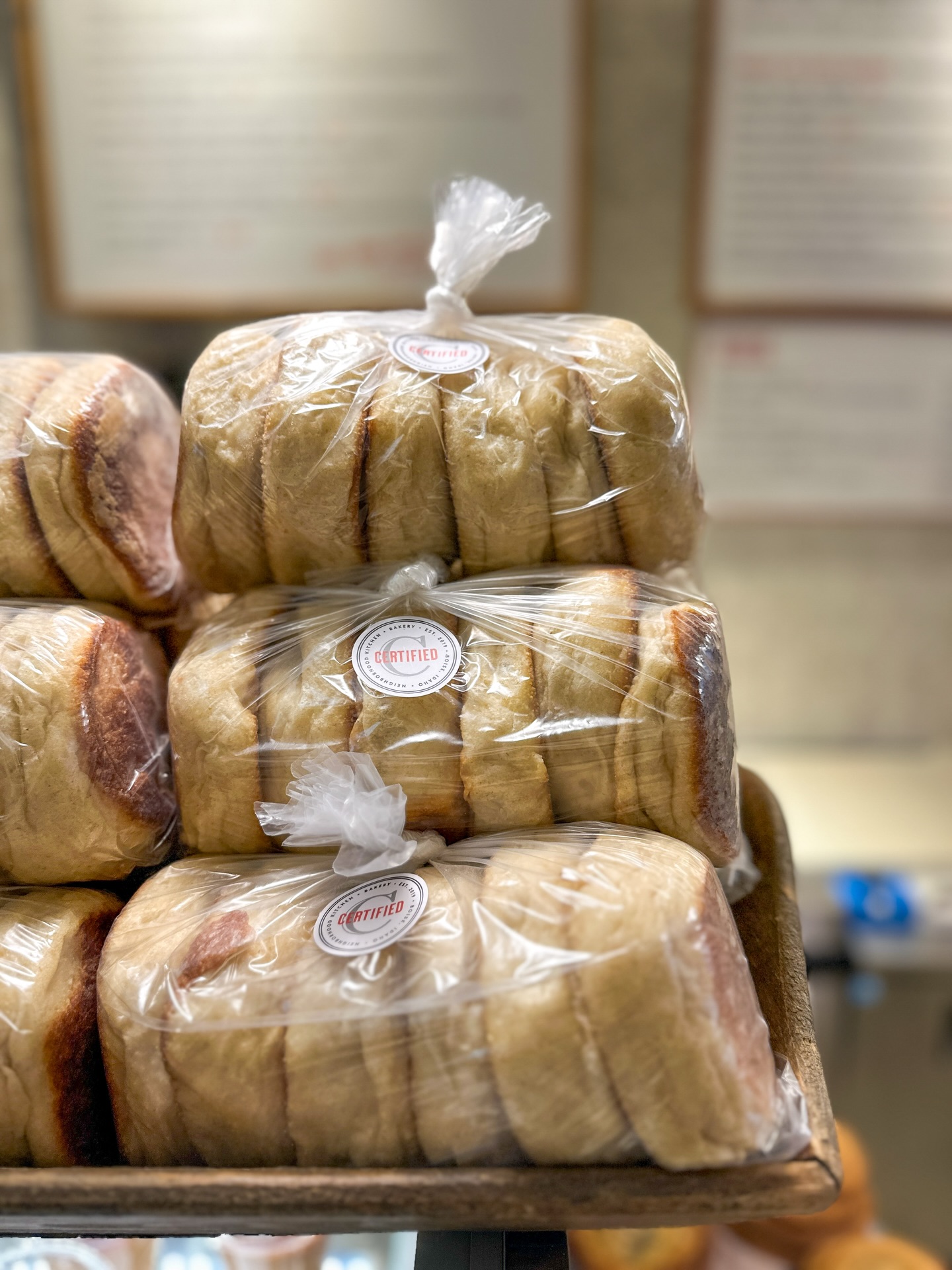 A fresh batch of sourdough English muffins, packaged and waiting by the counter.