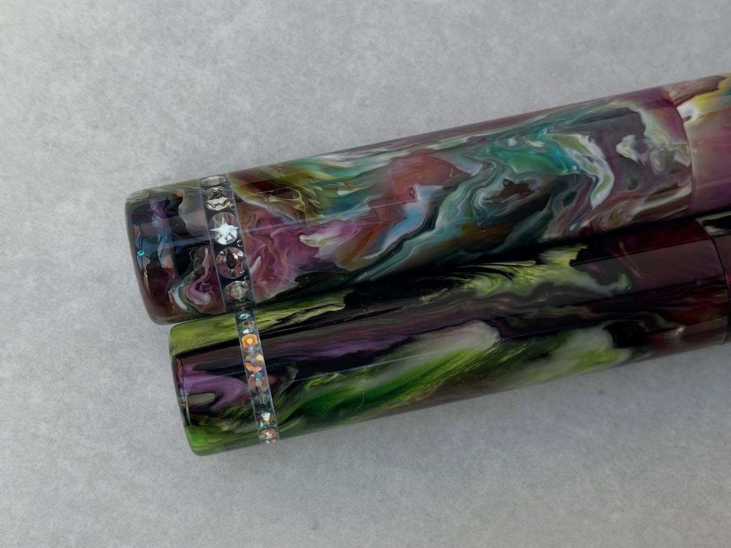 Swarovski pens… the first two.
So these have been a real test of my patience. I ADORE the finished pens BUT they’re not perfect.
I’ve tried several different ways to make them but some new issue seems to crop up.
These two are pretty good but if you look closely at the bands you can see tiny air bubbles trapped in the spaces between some of the crystals. Sigh.
The pens are still beautiful and they are still going up for sale this Friday at 8pm UK time
Do you prefer the narrow crystal bands on the Rose Garden Abalone or the fatter bands on the Primary Manipulation 6?
#blackrobinpens #fountainpenaddict #swarovski #fountainpen #fountainpencommunity