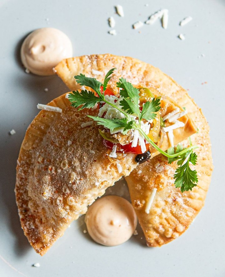 A top-down kind of temptation. Short Rib Empanadas with fermented black bean & tomatillo relish, queso fresco and chili remoulade. 🌶