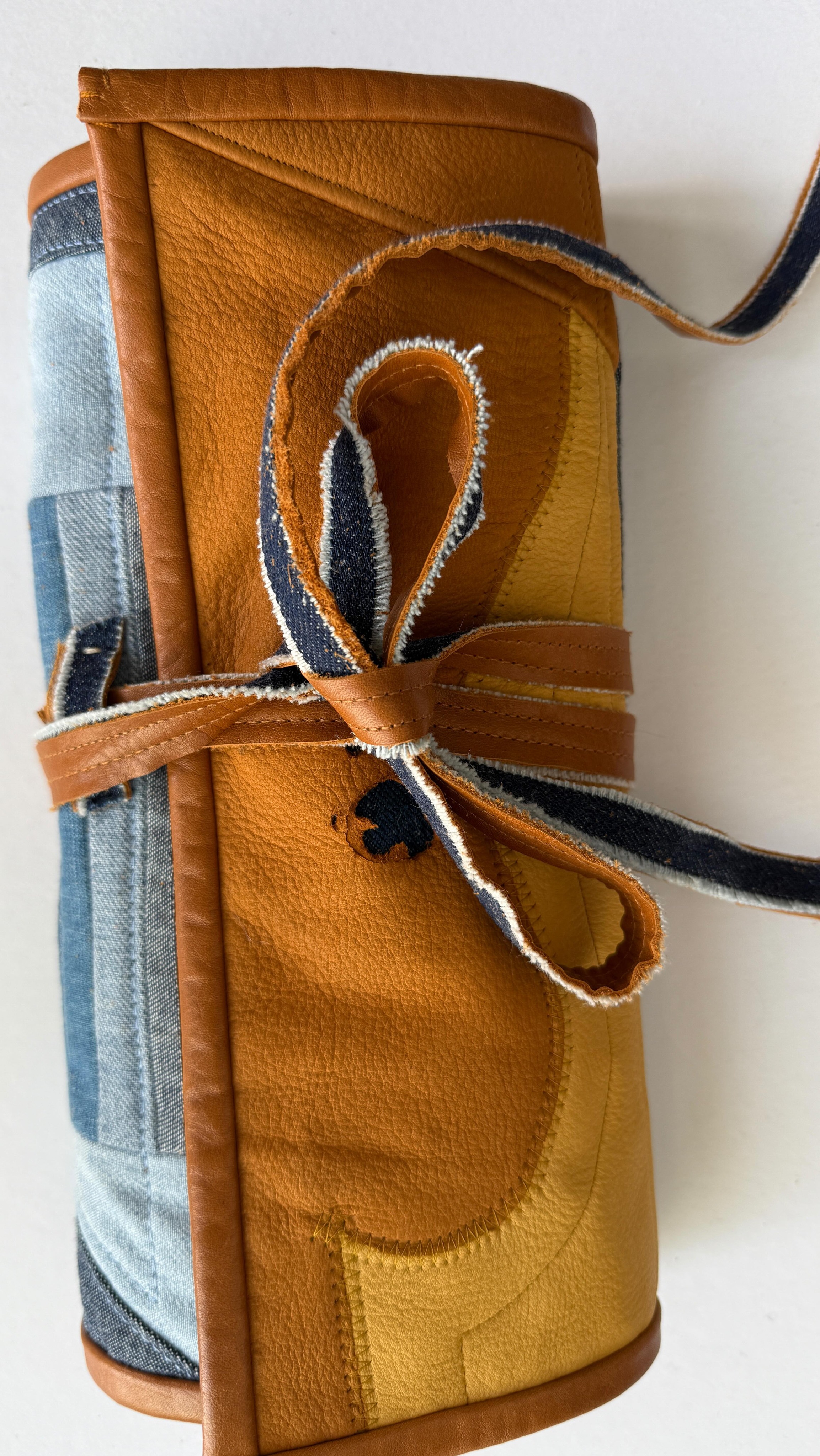 Does it matter if it’s functional? It’s gorgeous 🥹. No but really, I need it to work so I’ll be trying it out over the next couple weeks and seeing if I need to make any changes. Maybe another snap somewhere, or an extra pocket.
How did I create this? It was very technical 🤓.
1. Decided I wanted to use a leftover denim/leather quilt block for something. Thought… tool roll!!
2. Sewed some other stuff to it to make it a rectangle. How big a rectangle? Not sure, never measured ☺️.
3. Layered rectangle with batting and lining and quilted it.
4. Bound it with leather.
5. Went to my bag o’ leather scraps and chose some I liked.
6. Sewed the leather scraps to the inside in a formation that I thought looked logical.
7. Made a tie out of leather and denim.
Ta-da!
#upcycledjeans #toolroll