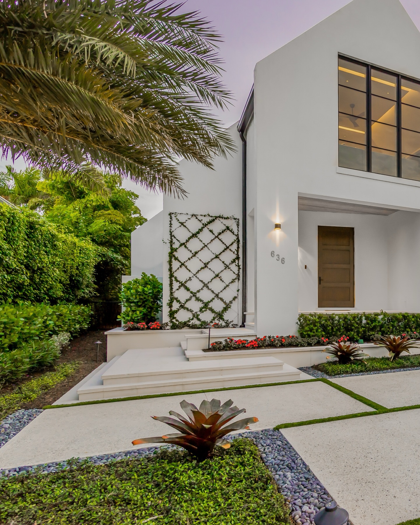 Tabby concrete meets modern coastal architecture. This custom driveway pairs shell-aggregate tabby slabs with crisp turf joints, creating a clean grid pattern that softens the hardscape while elevating curb appeal. Framed by layered tropical planting, trellis details, and warm architectural lighting, the arrival experience feels intentional, refined, and distinctly coastal. A fresh take on luxury driveway design in Naples that blends texture, geometry, and landscape seamlessly.
#TabbyConcrete #LuxuryLandscapeDesign #NaplesFLDesign #ModernCoastalArchitecture #HighEndHardscape