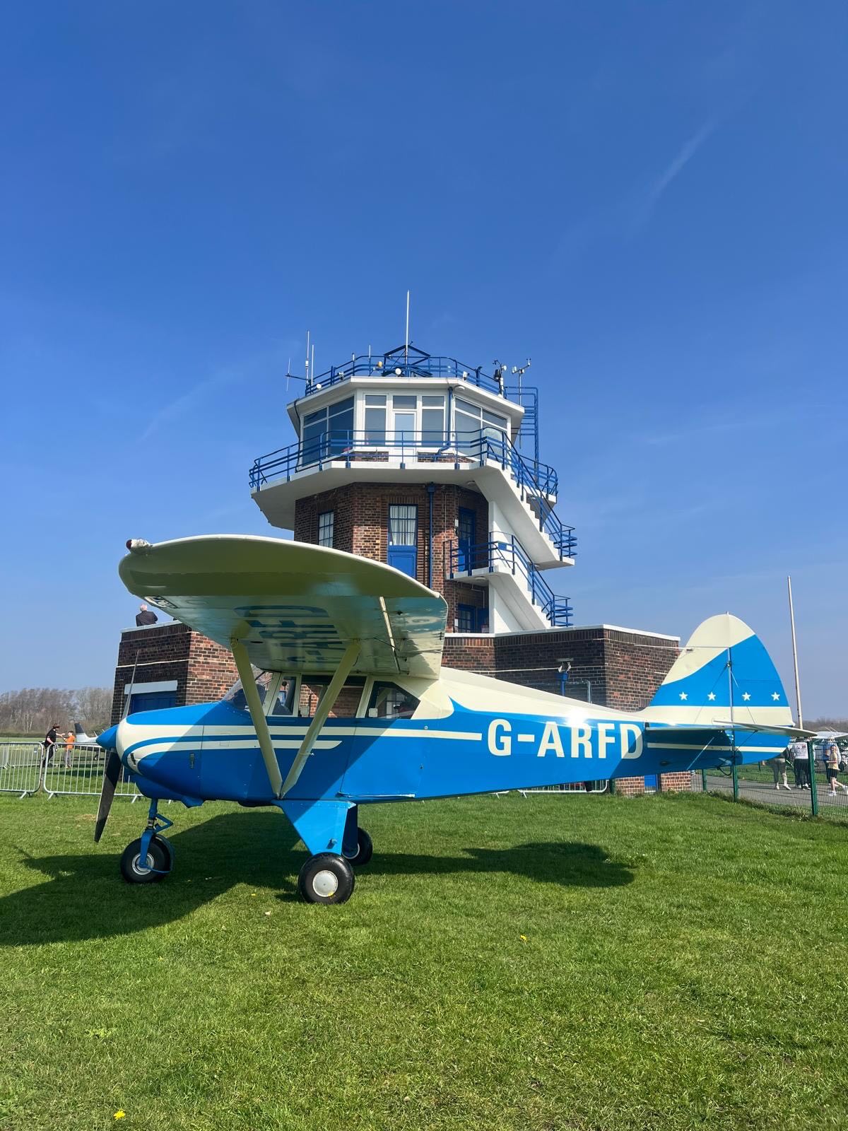 From black and white nostalgia to vibrant colour, these two photos of G‑ARFD capture a story only aviation can tell.
First photographed in the 1960s and recreated in 2026, highlight the continuity of Barton Aerodrome’s aviation heritage. The same aircraft, the same tower, and a long-standing commitment to general aviation that has defined the Aerodrome for decades. ✈️✈️