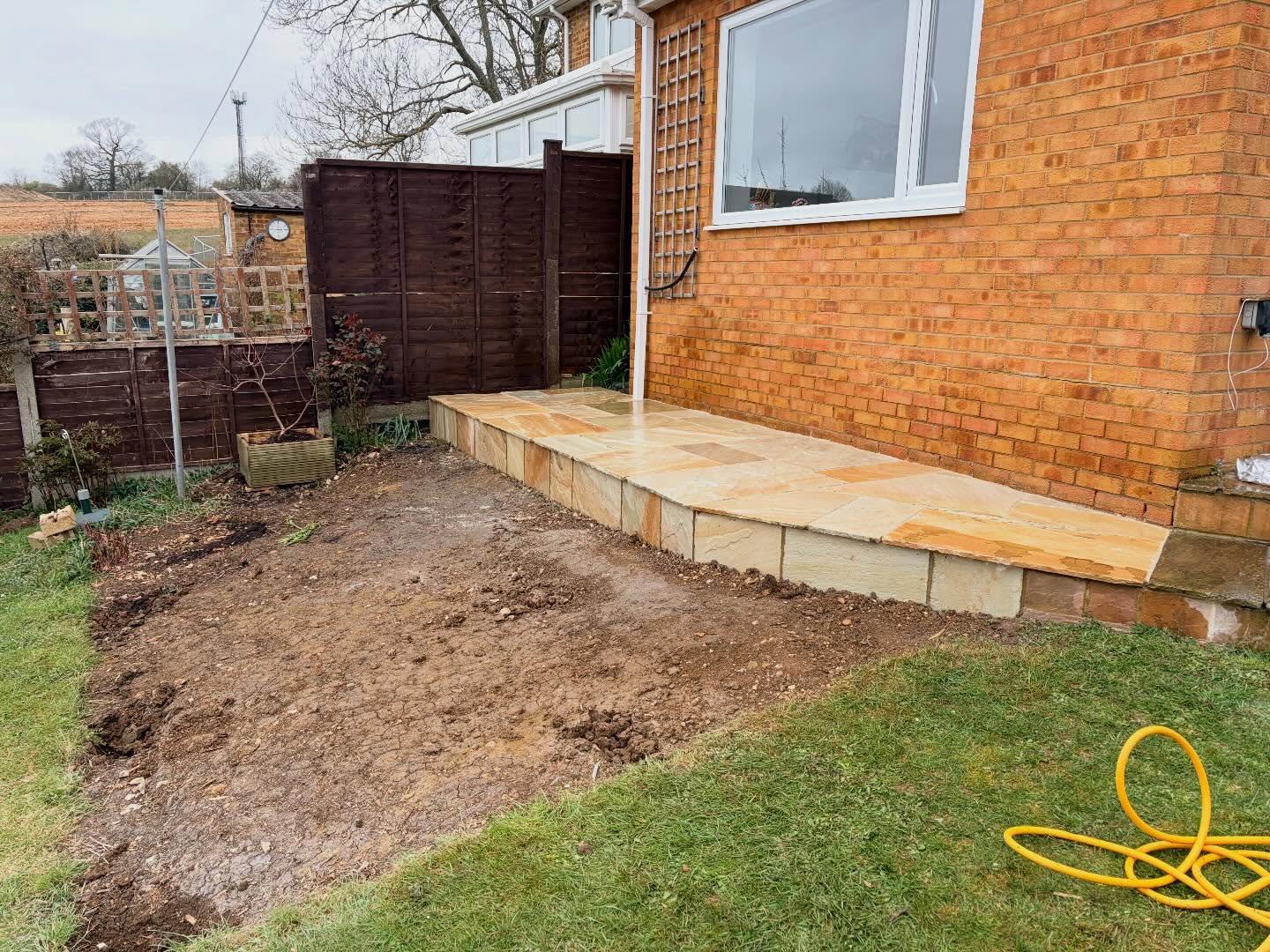 Another job done, out with the old decking and in with fossil mint sandstone, its going to look brand new once the rest of the patio is cleaned up for spring.#Alderson #building #patio #sandstone #paving.
