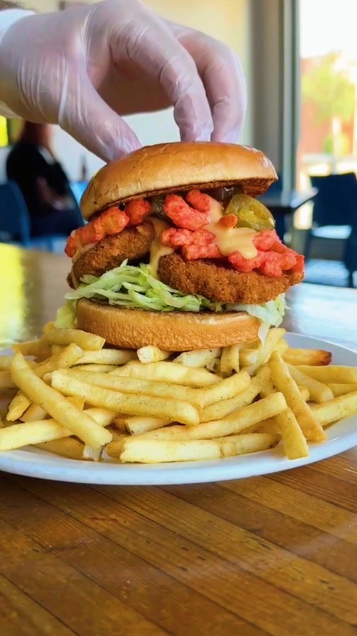 FLAMING HOT FOWL
Now at #greenPhx
Our house crispy fried chick’n stacked with shredded lettuce, crushed flaming hot @takisusa Pips for that electric crunch, melty EZ cheese, and a reckless hit of pickled jalapeños atop a mountain of thyme fries.
#alwaysvegan