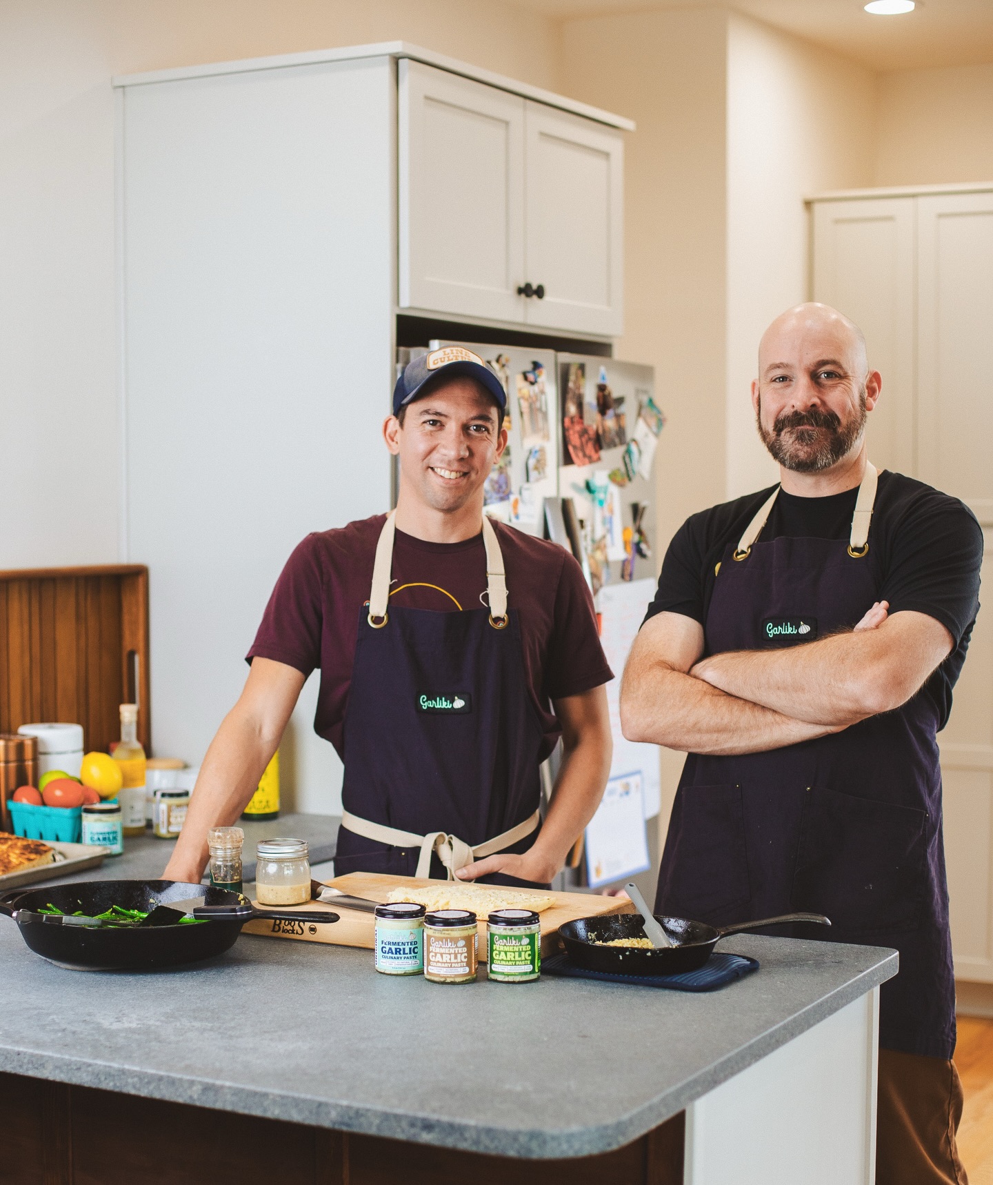 Garliki was born out of regular conversations and experimentation, prompted and prodded by enthusiastic friends and family. After years of fermentation trials and recipe development, this home kitchen concept morphed into a tangible reality ready to share with the masses.
Chris and Jason were discussing the virtues of good cooking one afternoon, and inevitably, garlic. They lamented peeling, crushing, and mincing garlic, and how the jarred garlic (jarlic) that you find on the supermarket shelves was good enough for nothing but the compost bin. They understood that fermentation has been known to enhance and preserve flavor in other food and beverages, so they began fermenting garlic in crocks and jars, then eventually converted kegs into larger fermentation vessels. The first batches were a revelation. Not only were they left with the garlic pungency they were looking for, but the fermentation process added depth of flavor they had never encountered. It was then Garliki was born.
Here at Garliki, craft and collaboration are in our blood. We value building, developing, and sustaining relationships founded on creative endeavors and rooted in community. The kitchen is our arena and fermentation is our passion. We aim to inspire experimentation and enthusiastic culinary experiences! We are so grateful you’re here for our garlic journey!
📸: @foragelocal