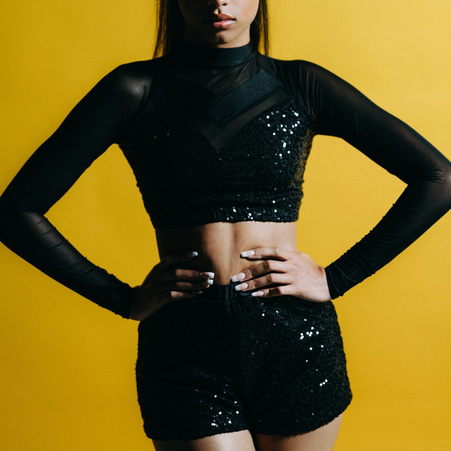 She's giving POM vibes!! Check out out best selling top "Nellie" with mesh cut-outs and sleeves with a gorgeous criss-cross back. Tons of colors to choose from so you can create a unique look for your team! What will you create? #dancecostumes #dancer #costumes