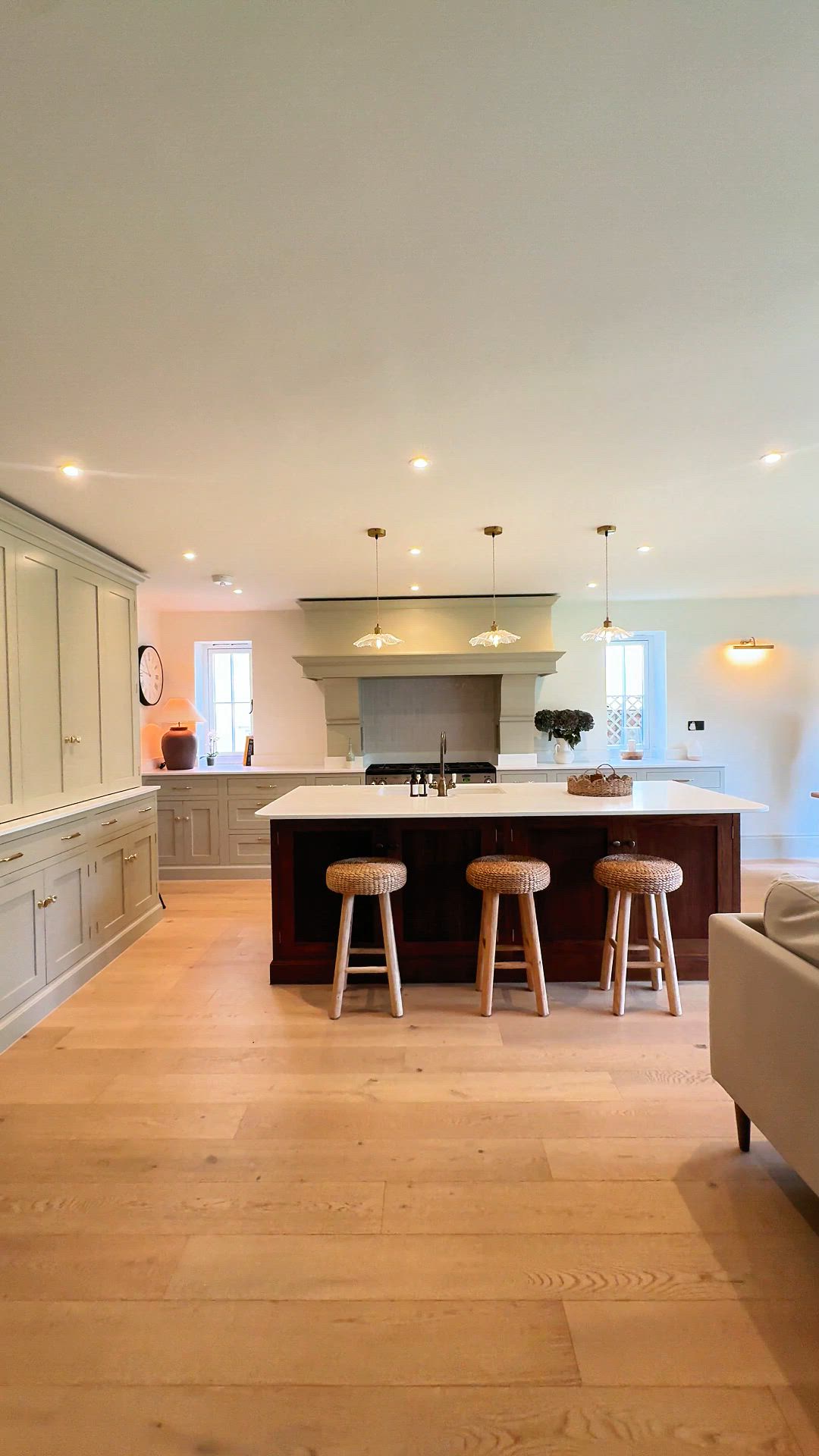 Traditional, bespoke, and finished in warm stained wood, complete with a feature mantel. Take a closer look. #BespokeDesign #KitchenInspo #InteriorDesign #ModernLiving