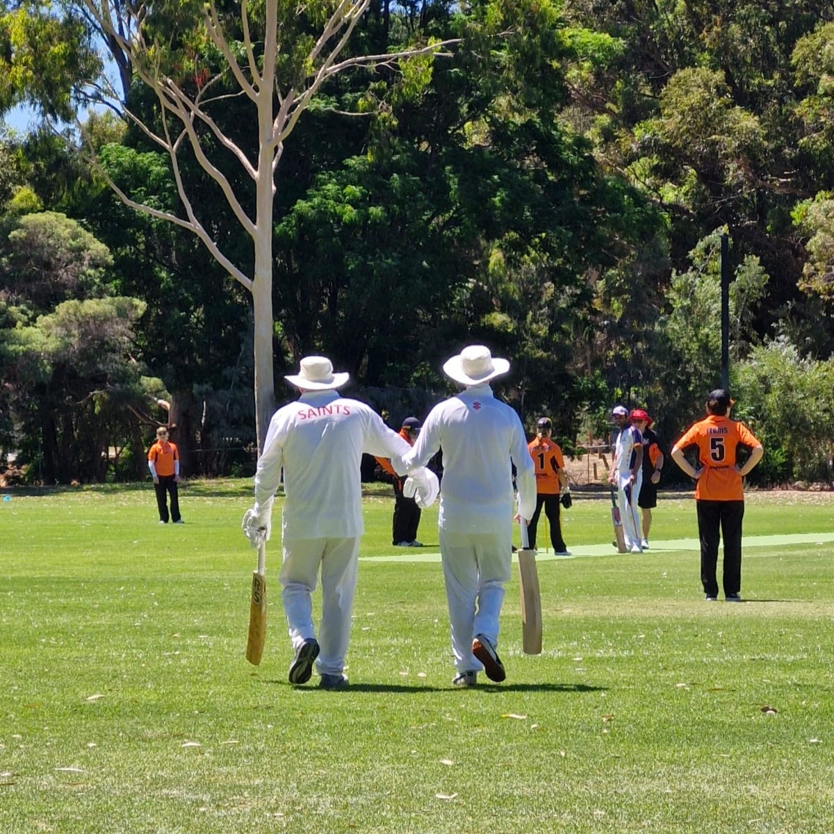 MVCA players take the opportunity to walk in someone else's shoes and play the WA state vision impaired team before their National tounament. Here a player wearing full block glasses is needing a helping hand out the pitch.