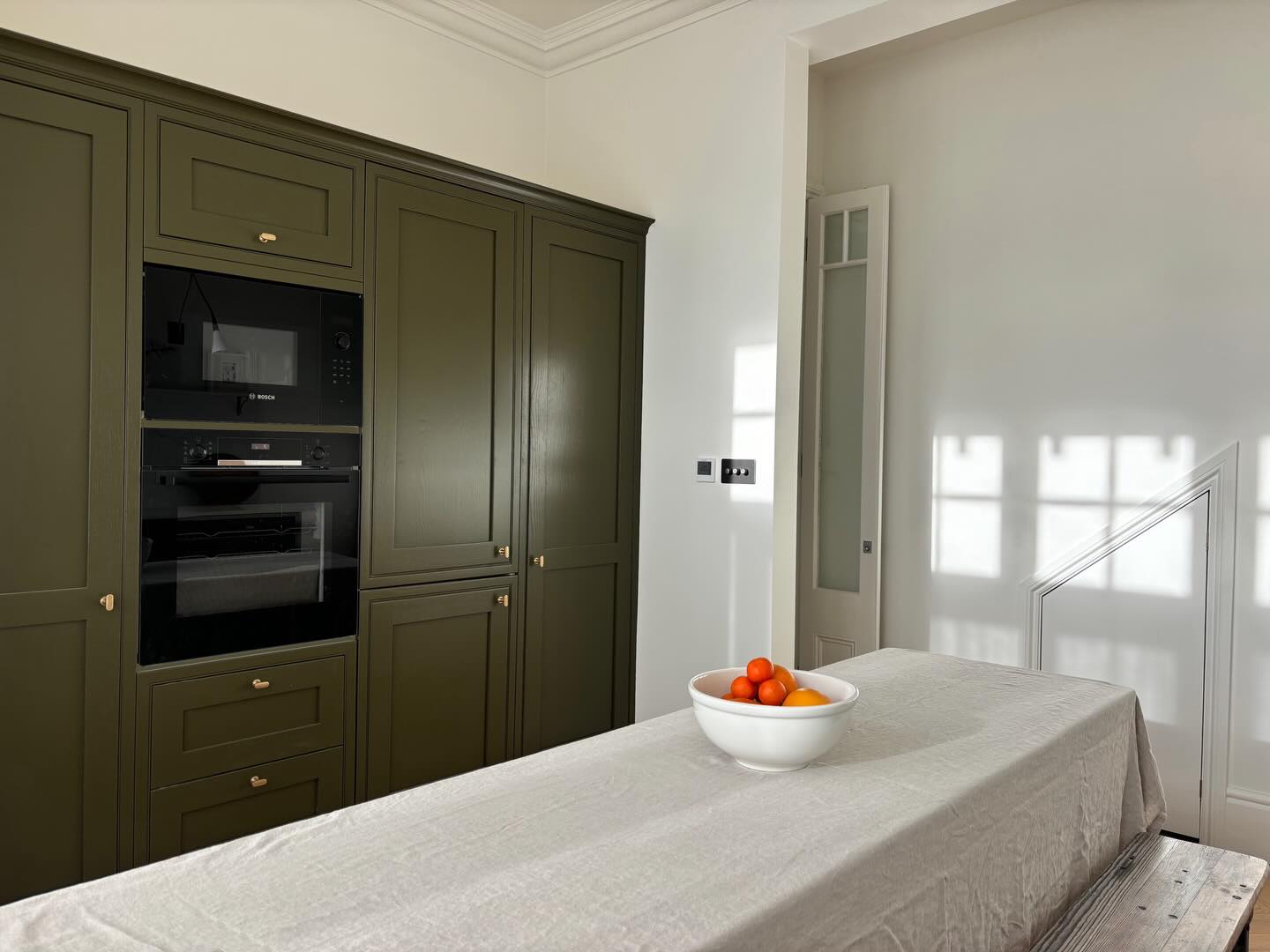Swipe for some before and afters at our Wimbledon project, London. We reduced the kitchen unit run a little so that we could add a much-needed ground floor wc in the space under the stairs. We focussed tall units along one wall to maximise storage whilst keeping the opposite side low and open with a bespoke hidden cutlery drawer under the hob. The whole space works much better and feels much lighter and more open for our senior client.