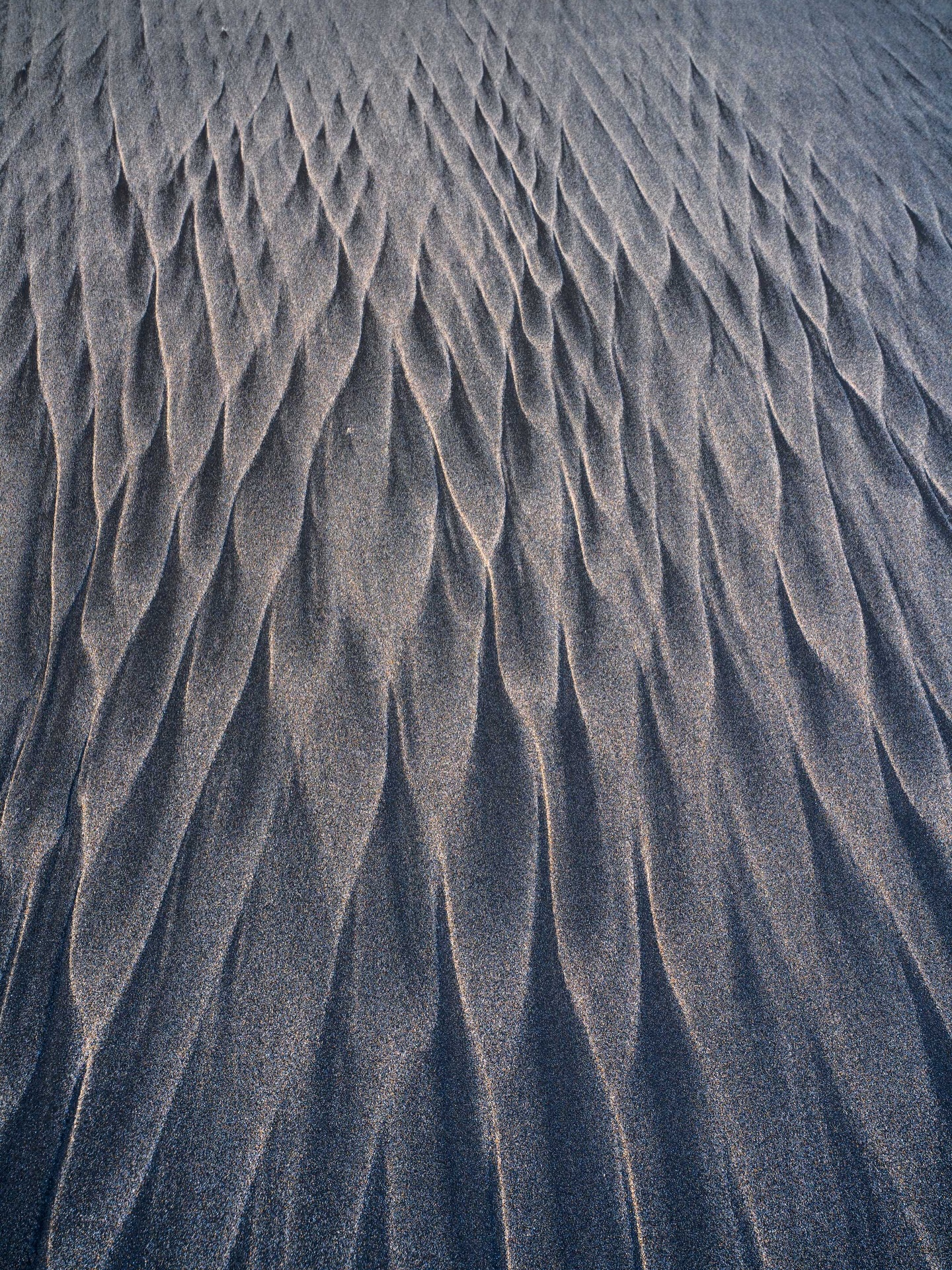 Unexpected, yet familiar.
Sometimes, you discover familiar patterns in the most unexpected places. Last year, on the beaches of the Lofoten Islands, I watched waves carve delicate, rhythmic structures into the sand.
During my recent trip to Asturias, I was amazed to find these same patterns appearing again: echoes of a place far away. There’s something deeply beautiful about this fleeting art: shaped by the sea, erased, and endlessly recreated with every passing wave.
Shot on Sony A7 RV + 16-28mm f/2.8 Contemporary DG + Maven Filters Polariser + framed on Gitzo Systematic Tripod.
