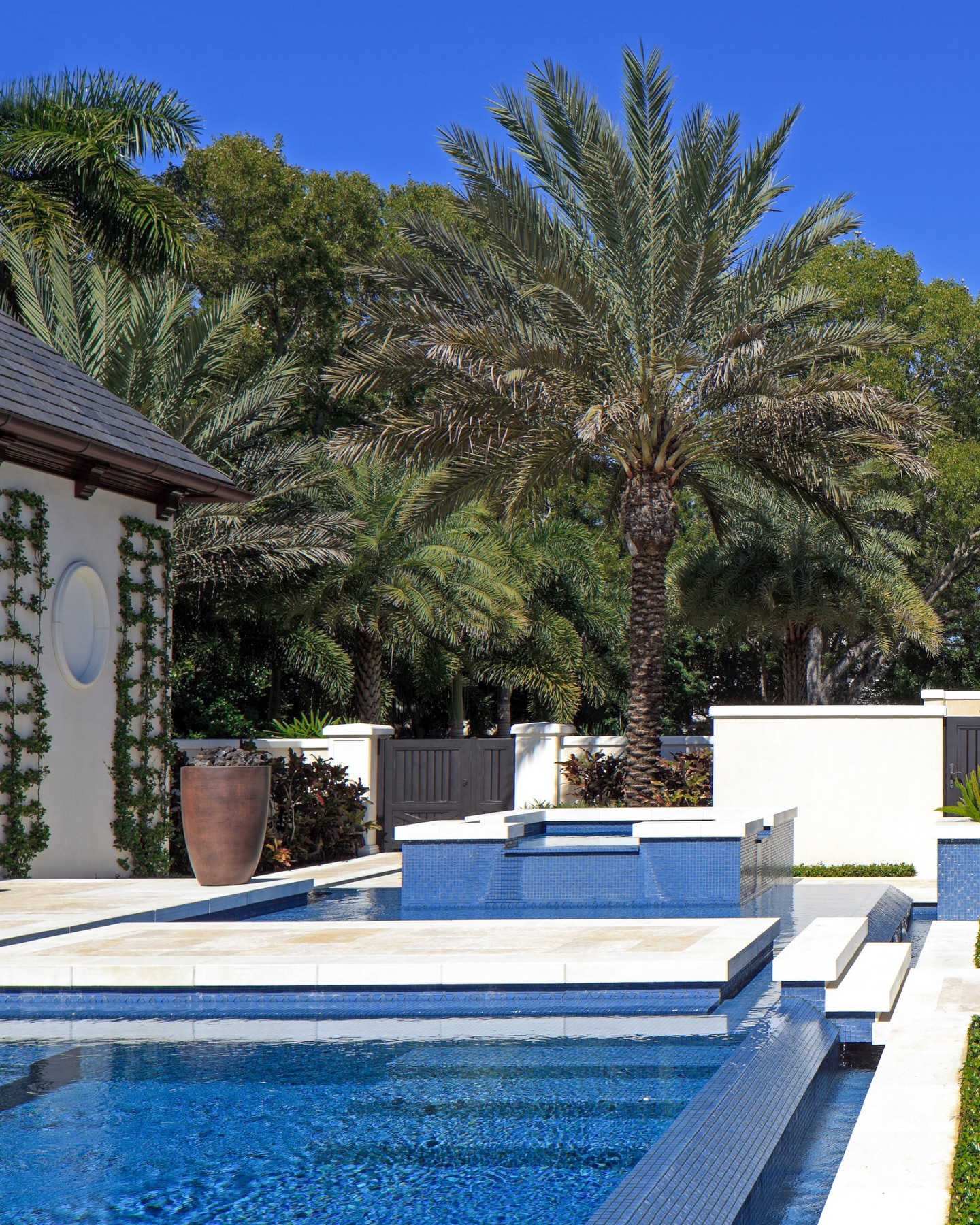 Not all backyards are meant to be seen at once. This one unfolds step by step. Floating pathways skim across the water, layered terraces create moments of pause, and a raised spa becomes the quiet focal point framed by palms and tropical texture. Every line is intentional, every view composed, a modern Naples outdoor living space designed to feel discovered, not just designed.
#NaplesLuxuryHomes #OutdoorLivingDesign #LuxuryPoolDesign #NaplesLandscapeArchitecture #FloridaCoastalLiving