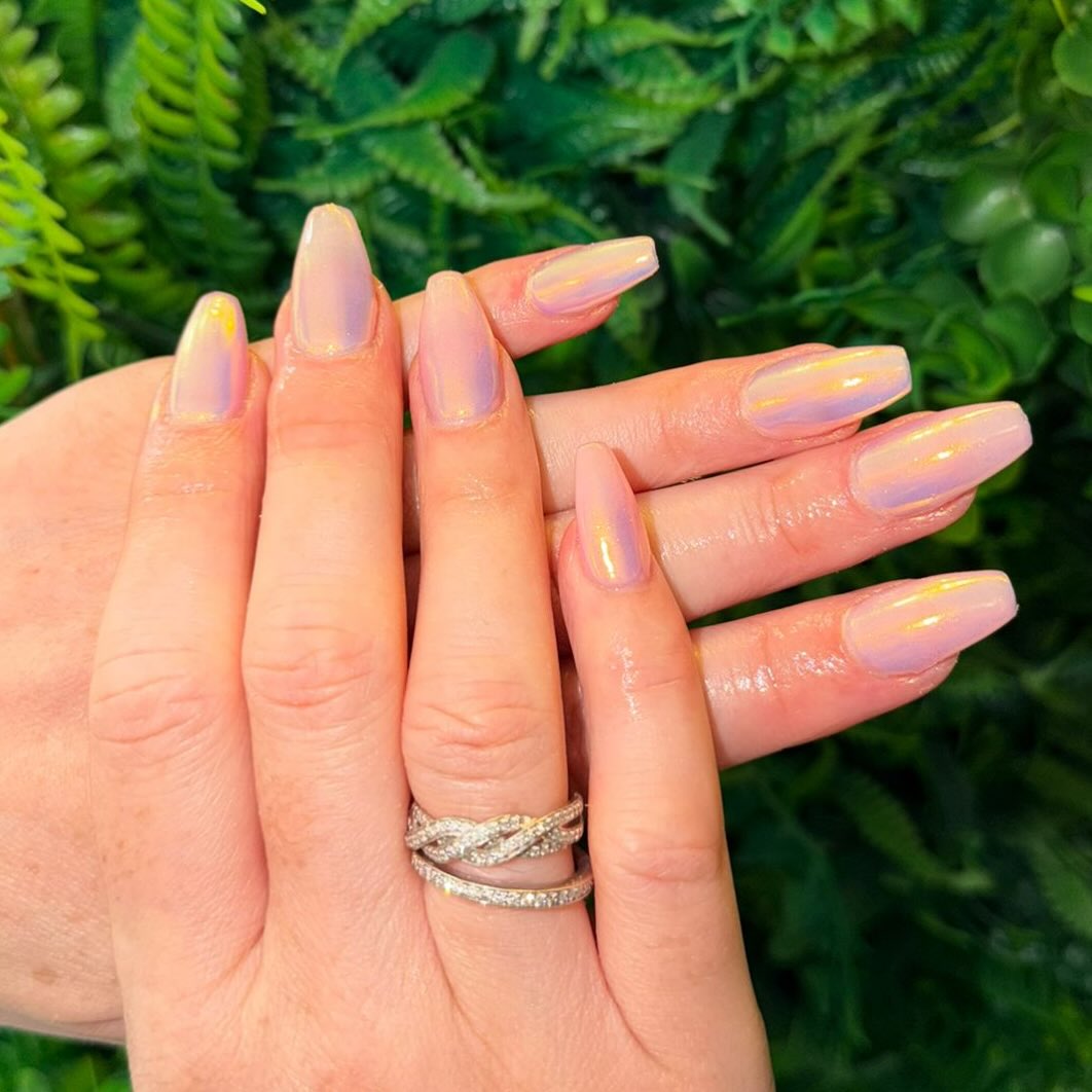Soft glam with a twist ✨💅
These dreamy almond nails by Senior Beautician Jemma feature a sheer blush pink base with a luminous iridescent chrome finish, catching hints of gold, peach, and lilac in every light 💖🌈
Elegant, glossy, and effortlessly chic — the perfect balance of natural beauty and subtle shine.