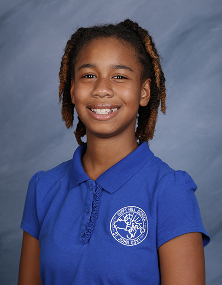 This is seventh grader Amia Smith’s sixth year as part of the GHS community. She says she appreciates the way our teachers challenge their students.
“I like that I can ask Ms. S. math questions and she explains it in a way I can understand,” says Amia. “I get free hugs from Ms. Banen which makes my day better, and I can ask Ms. Francis questions about Virgin Islands history and I get accurate answers.”
Amia possesses a quiet determination and a subtle sense of humor, say seventh grade co-advisors Ms. Banen and Mr. Corey.
“She’s a calming presence among her classmates,” says Ms. Banen. “She’s really good about making people feel comfortable and she's a very supportive friend.”
“Her thoughtful personality always shines through,” adds Mr. Corey. “She works hard, stays focused, and puts in genuine effort. She’s a true joy to have in class.”
Amia says her classmates are funny and sweet, and they treat one another respectfully. Social studies is her favorite subject because it challenges her, and STEAM is her favorite elective. Amia often chooses the theater option during STEAM Week because she enjoys acting.
“She’s a fantastic performer,” says Ms. Banen. “She surprises me each time with her passion for it and her ability to embody her character.”
Amia is part of our after school singing club with Ms. Rashida. In her free time, she enjoys calling her friend Leanna to play Roblox, going to the beach and the playground, and getting ice cream.