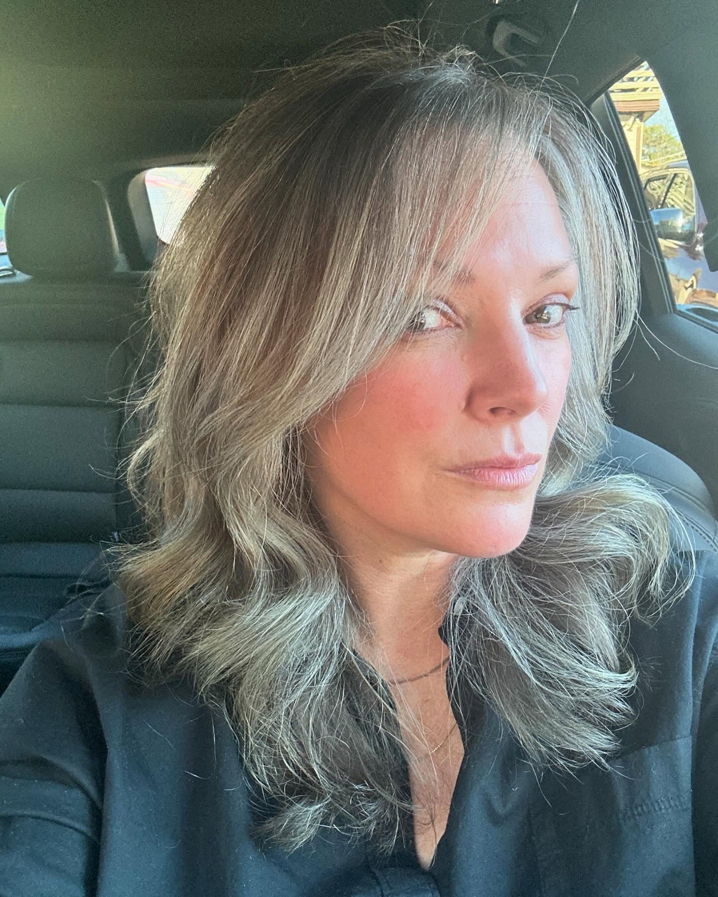 There’s nothing more valuable than time. And I’ve learned, through my mom’s journey with early-onset Alzheimer’s, just how fragile it is. She was diagnosed at 60. Now at 71, she no longer knows who we are. My mom’s last job (for almost 20 years) had her working seven days a week, most weeks. I wish I could give that time back to her. My boys missed out on knowing the incredible, kind and fierce woman she is - someone who always made people feel seen and cared for.
I’m doing my best to make intentional choices - being present with my boys, not working every second, and creating moments that matter. One of the choices is not coloring my hair. Spending hours in a chair, planning my life around appointments or paying for chemicals I don’t even want on my scalp.
Who decided grey hair is something we need to hide (especially women)? Society’s expectations of aging have no place here. I refuse to let anyone else define what aging should look like. We all deserve to live as our authentic selves – whatever that looks like for each of us.
This is my choice. And the beautiful thing? We all have that choice.
#ambedoskin #grey #greyhair #agepositive #proaging #teamrubyandclover