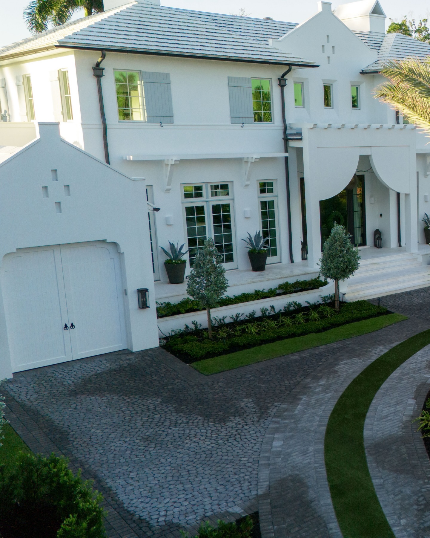 Morning dew still resting on the driveway as the first light of sunrise glides across this Naples estate, revealing a quiet arrival designed to feel both grand and effortless. A sweeping motor court, layered tropical plantings, and sculptural palms guide the approach, while the central fountain anchors the experience with timeless elegance. Soft morning shadows, crisp architectural lines, and rich textural hardscape create an entry sequence that feels calm, curated, and unmistakably luxurious. This is the kind of arrival that sets the tone before the day even begins.
#NaplesFL #LuxuryLandscapeDesign #EstateEntrance #FloridaLuxuryLiving #LandscapeArchitecture