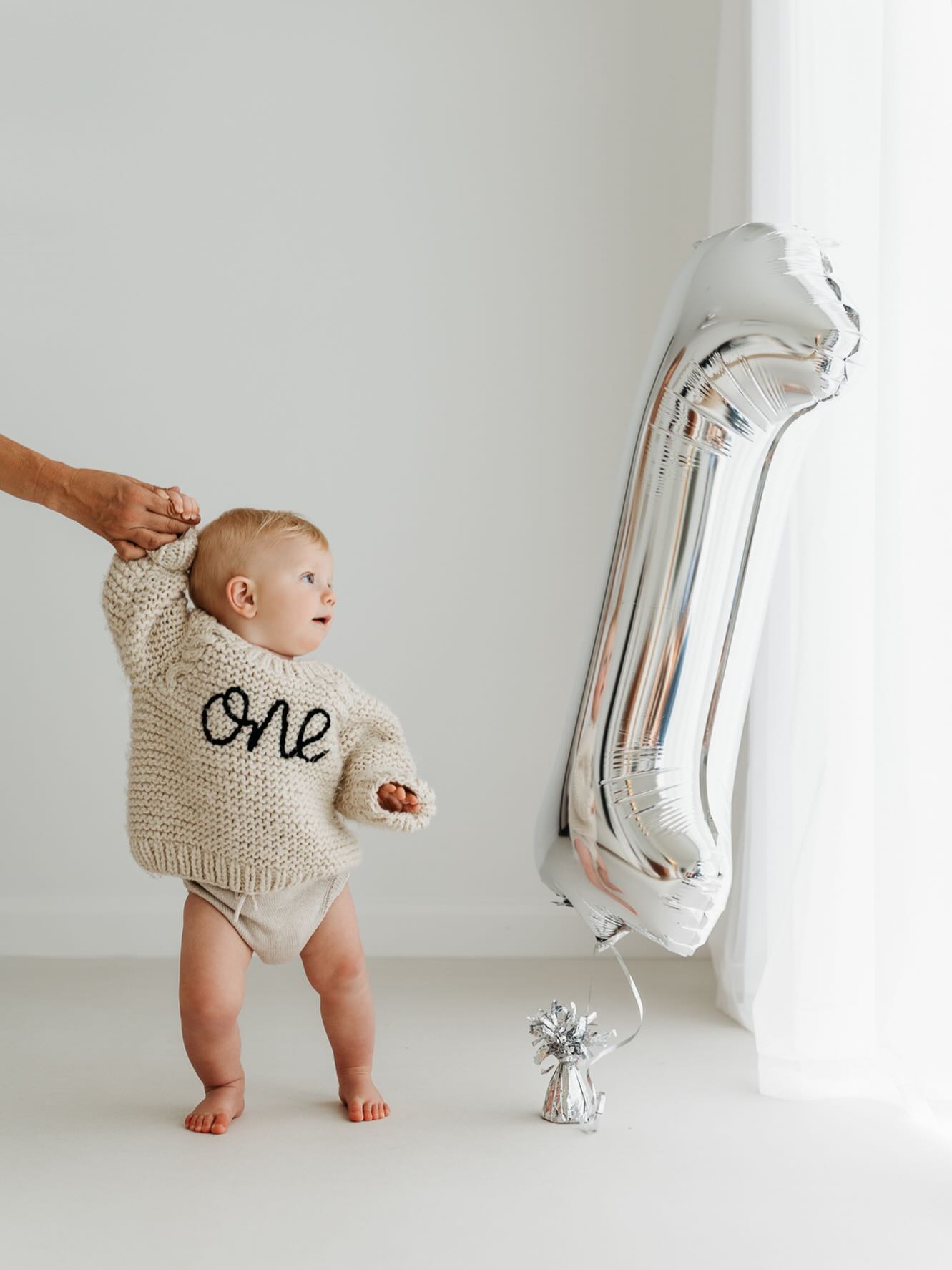 You don’t need bright colours, elephants, giraffes, bunting and braces etc for your first birthday session.
Just a couple of simple and neutral props for them to engage with and the rest is all about capturing baby, and all their little quirks. Seeing their character emerge as they’re still a baby, on the verge of toddlerdom.
If you’re looking for something tasteful and timeless to help you celebrate this wonderful milestone, I’d love to hear from you. 🥰