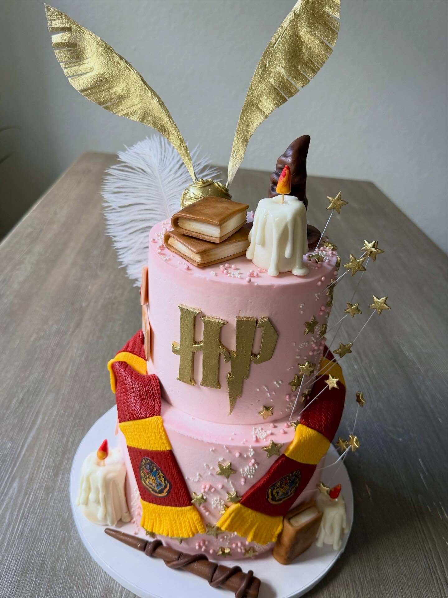 Harry Potter themed sweet 16 birthday cake. Edible handmade details included: envelops, books, scarf, stars, candles, golden snitch, hat and wand.