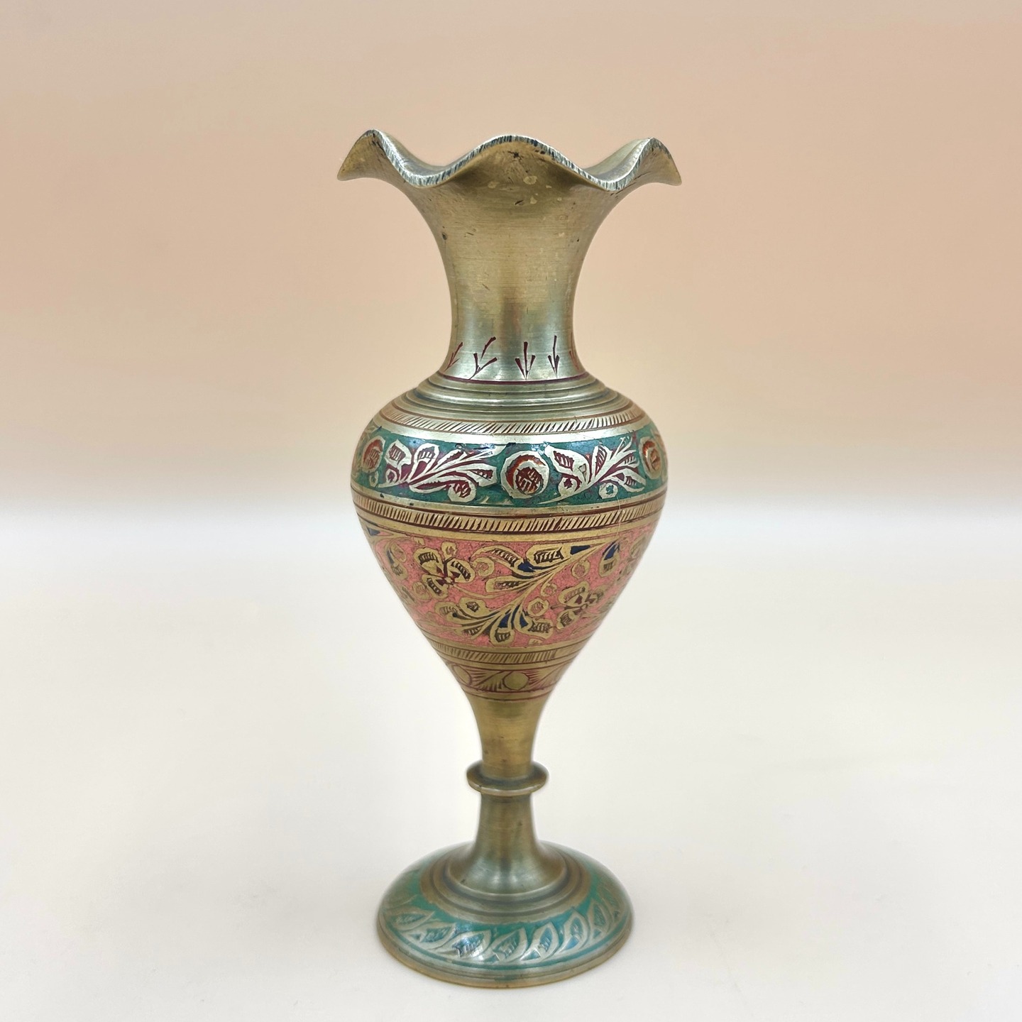 🟢 DOSTĘPNY | Wazon w stylu mogolskim, Indie, Kaszmir, lata 70. XX w.
Wazon mosiężny zdobiony w motywy botaniczne, grawerowany ręcznie, emaliowany.
Smukła, wydłużona forma z falistym wylewem i stopą nawiązuje do tradycyjnych wyrobów rzemiosła subkontynentu. Ornamentyka roślinna w pasach dekoracyjnych odwołuje się do estetyki indo-perskiej.
Tradycja tego typu metalowego rzemiosła w Indiach sięga co najmniej kilku tysięcy lat - już w cywilizacji doliny Indusu (ok. 2500–1500 p.n.e.) rozwinięta była obróbka metali, w tym brązu i miedzi. W późniejszych okresach, zwłaszcza od średniowiecza i epoki Mogołów (XVI–XVIII w.), nastąpił rozkwit wyrafinowanych technik dekoracyjnych, takich jak grawerunek, inkrustacja czy emalia (meenakari).
Wys. 13 cm
95 PLN + 15 PLN koszt przesyłki