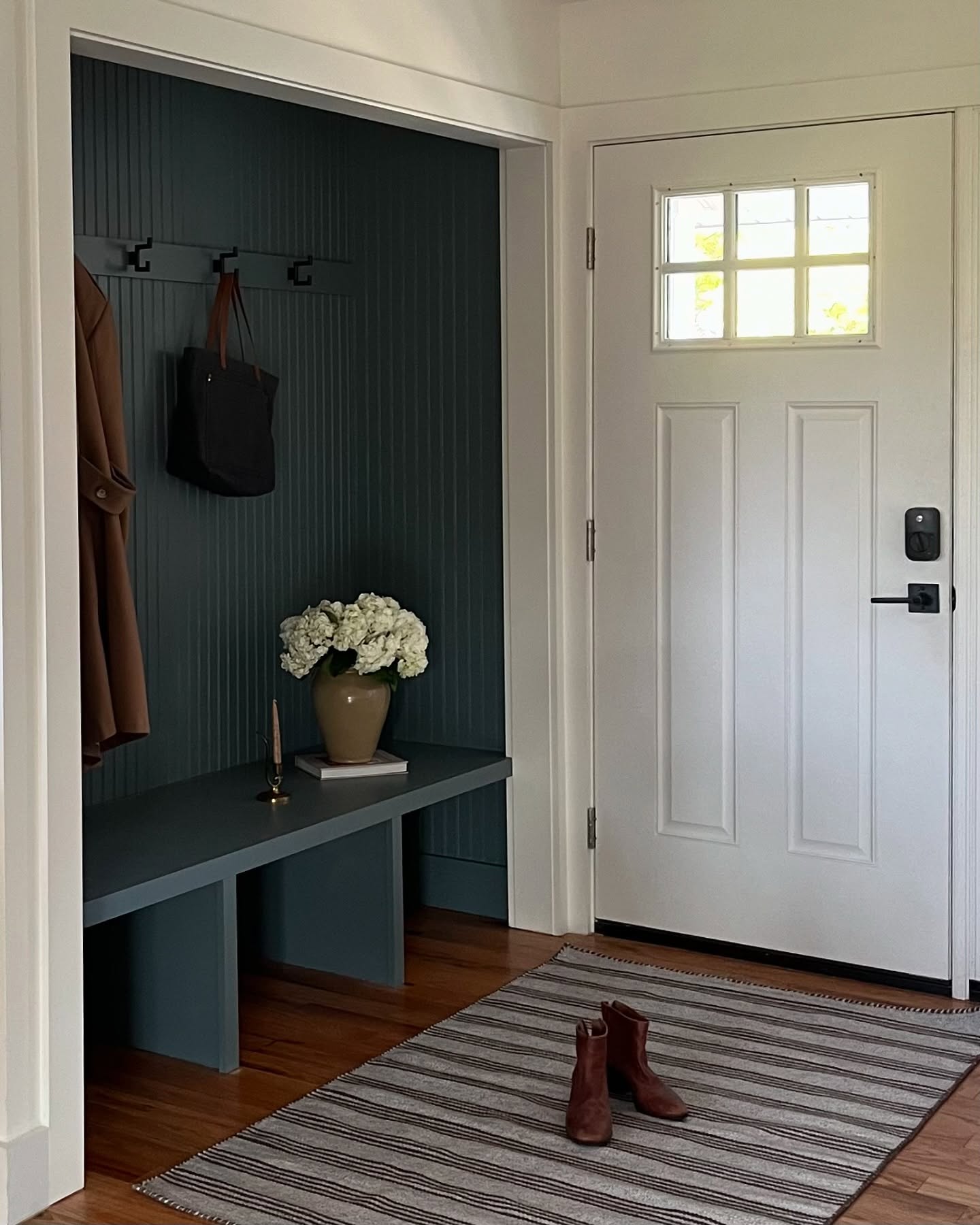 Tiny entryways can be cute too. Phone snap of this closet turned mini mudroom.