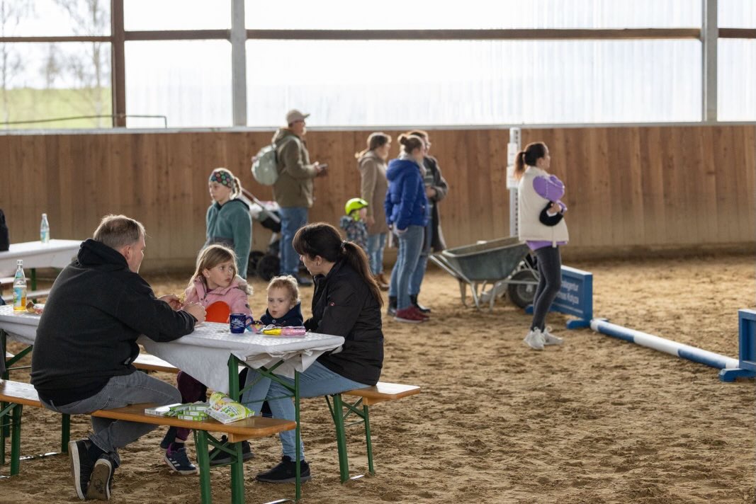 Am vergangenen Wochenende fand unser Oster-Kindernachmittag für Kinder im Alter von 2 bis 5 Jahren statt. 🐣
Zu Beginn bekam jedes Kind einen Laufzettel, auf dem die erfolgreich absolvierten Stationen abgestempelt wurden. ✅ Dabei konnten die Kinder auf unseren Schulpferden reiten, Ostereier im Hof suchen, beim Eierlaufen ihr Geschick zeigen und im Reiterstübchen kreative Ostersachen basteln. ✨
Bei der Eiersuche war außerdem ein besonderer Hauptpreis versteckt: ein Gutschein für eine Reitstunde. Herzlichen Glückwunsch an die stolze Gewinnerin! 🎁🐴
Alle waren mit viel Freude dabei und haben die Stationen richtig toll gemeistert. Am Ende durfte sich jedes Kind über eine Schleife und eine Urkunde als Erinnerung freuen. 🎀
Natürlich war auch für die Eltern gesorgt. Sie konnten den Nachmittag bei Kaffee und Kuchen genießen. ☕🍰
Ein herzliches Dankeschön geht an unsere @franziska_dau und @_latifisa_ für die tolle Organisation sowie an alle fleißigen Kuchenbäcker, Hofkehrer, Pferdeführer, Osterhasen, Bierbankaufsteller und -abbauer und Puzfeen, die mit angepackt haben und diesen schönen Nachmittag möglich gemacht haben. Ihr seid einfach super! Besonders freuen wir uns auch über das große Engagement von Seiten unserer Reitschüler. Es war richtig schön, dass ihr auch mit dabei wart!🙏❤️