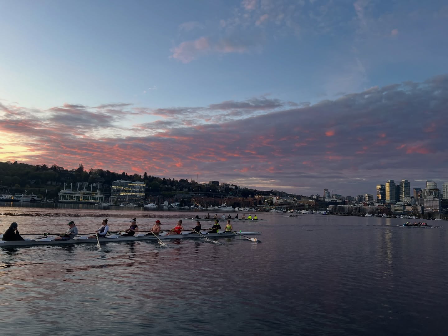 Three 8+s and a 4x walk into the sunrise… Women’s Competitive Team with the big boats across Lake Union this morning!