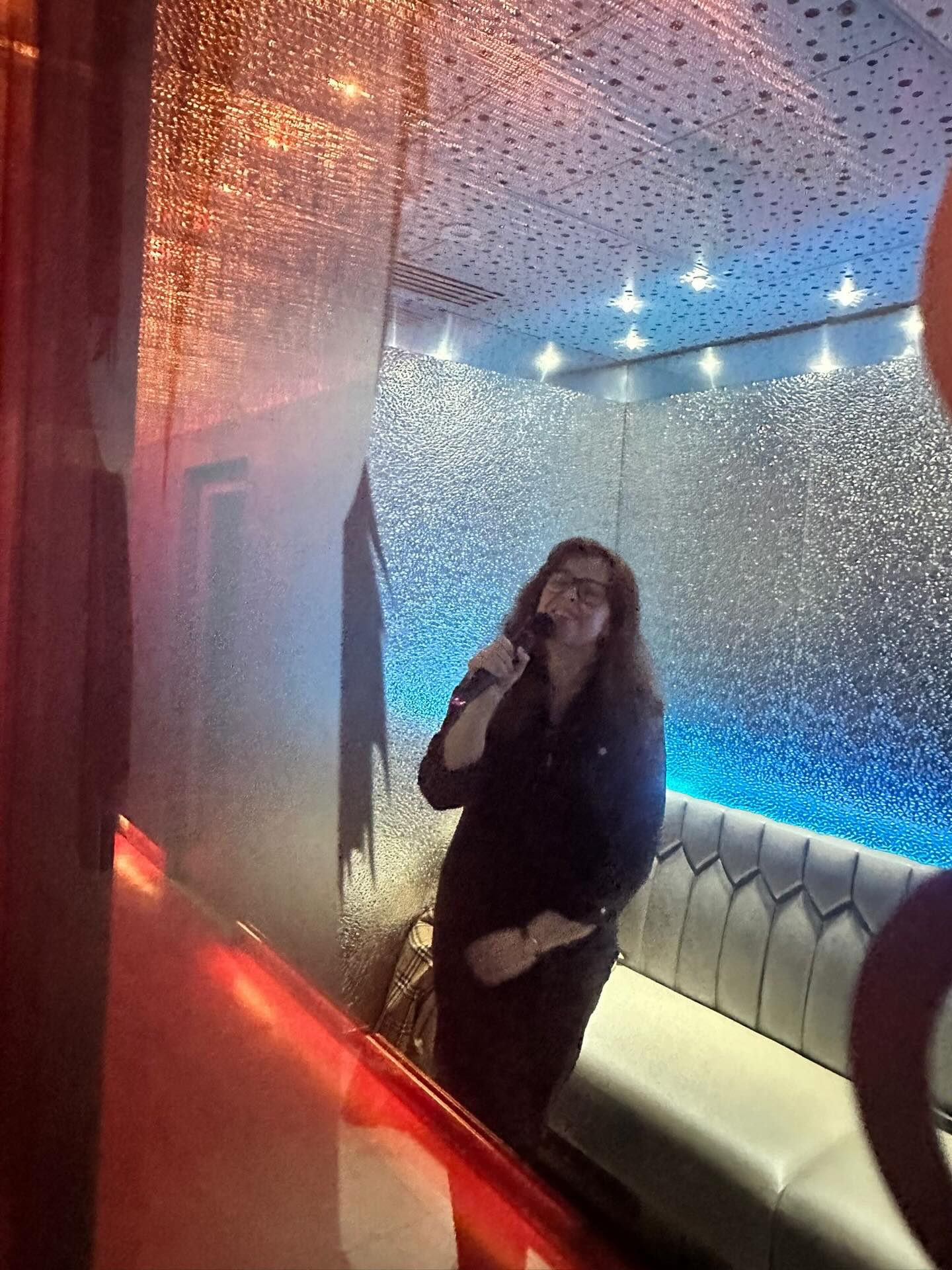 @jillianbatts took this picture of me temporarily singing karaoke alone - it’s very ‘padded cell, but make it fun’ 😂