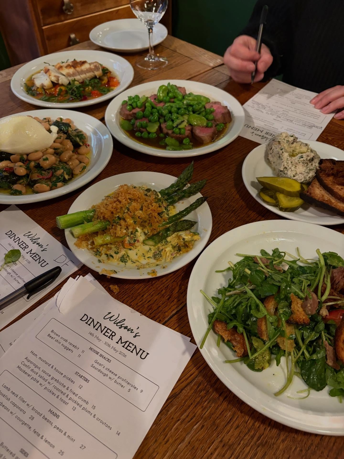 It’s what you’ve been waiting for… this new menu is running until the end of this month. So book in or risk missing out on:
Asparagus, sauce gribiche & fried crumb
Confit duck salad w/ roasted & pickled plums & croutons
Mackerel pâté w/ pickles & toast
Lamb neck w/ minted peas
Monkfish caponata
Butter beans with courgette & feta
Some serious wines from the UK and France
Get yourself down to Wilson’s!