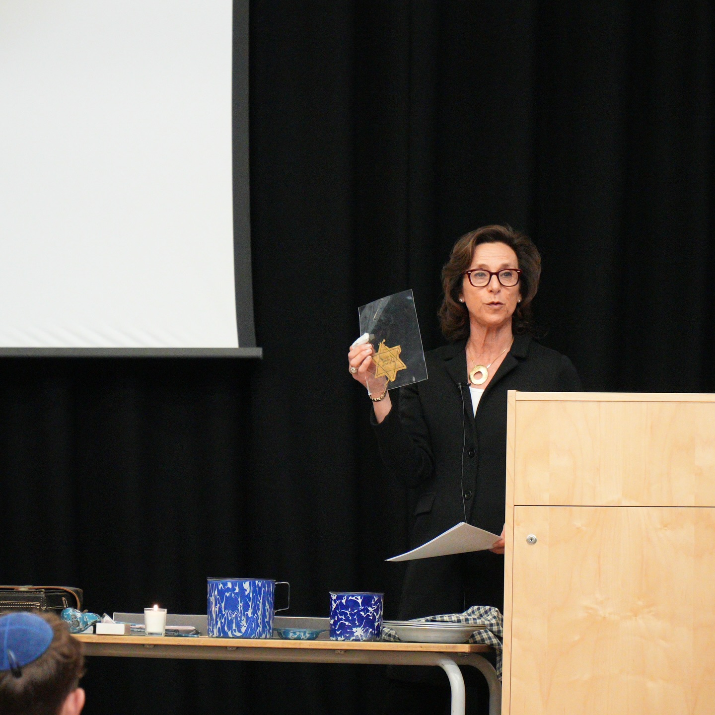 As part of Yom HaShoah commemorations, all of Year 9 with Year 12 and 13 history students were privileged to hear from Hephzibah Rudofsky who is the daughter and granddaughter of Holocaust survivors. She showed artefacts, letters, photographs, and documents collected and preserved by her mother, Zahava Kohn MBE, and grandmother during their time in Westerbork, Bergen-Belsen, and Biberach camps.