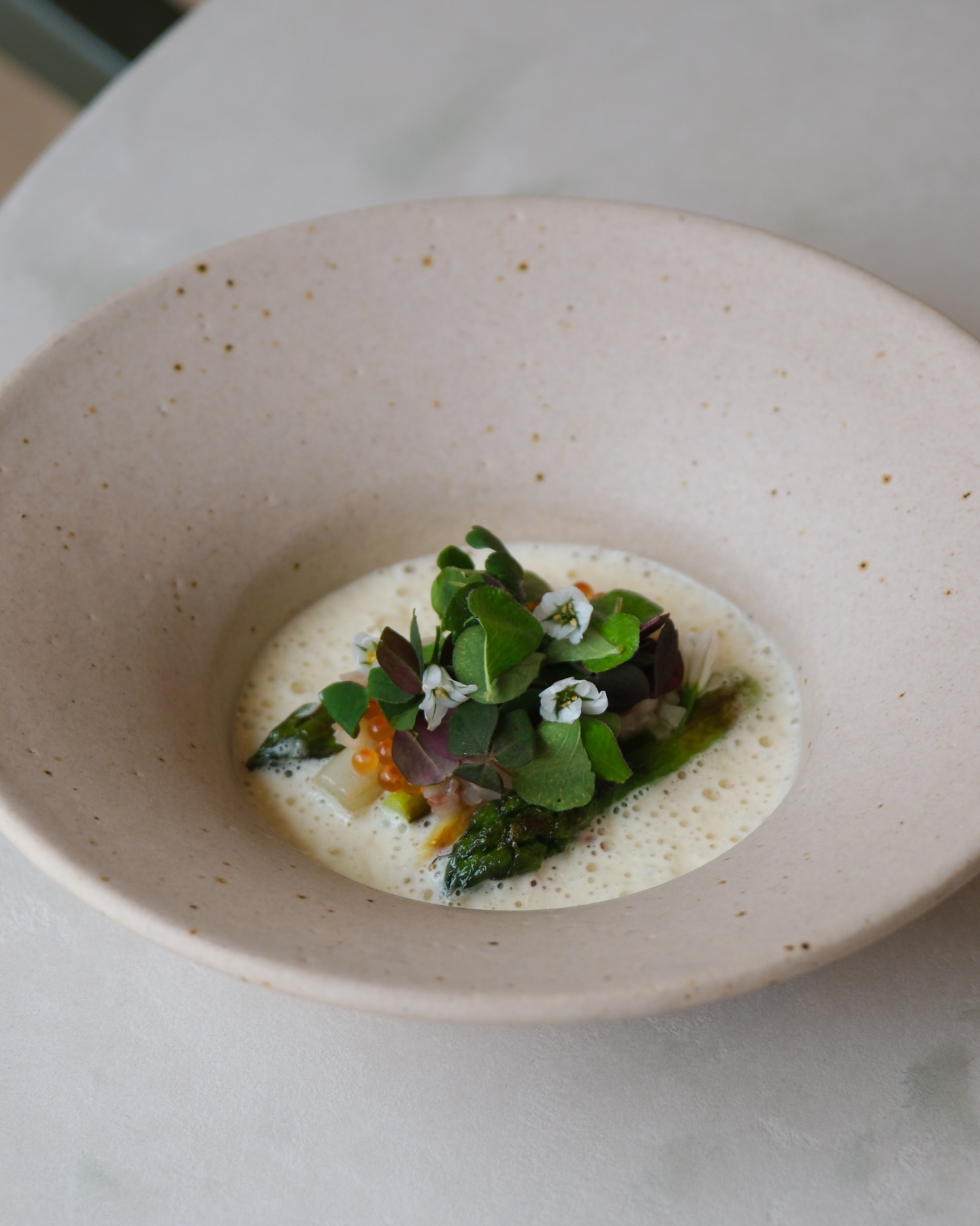 Available as part of our tasting menu, this dish features tender white and green asparagus with fermented asparagus, pickled rose, plum blossom vinegar, trout roe, and fresh sorrel, all brought together with a delicate Vin Jaune sauce.