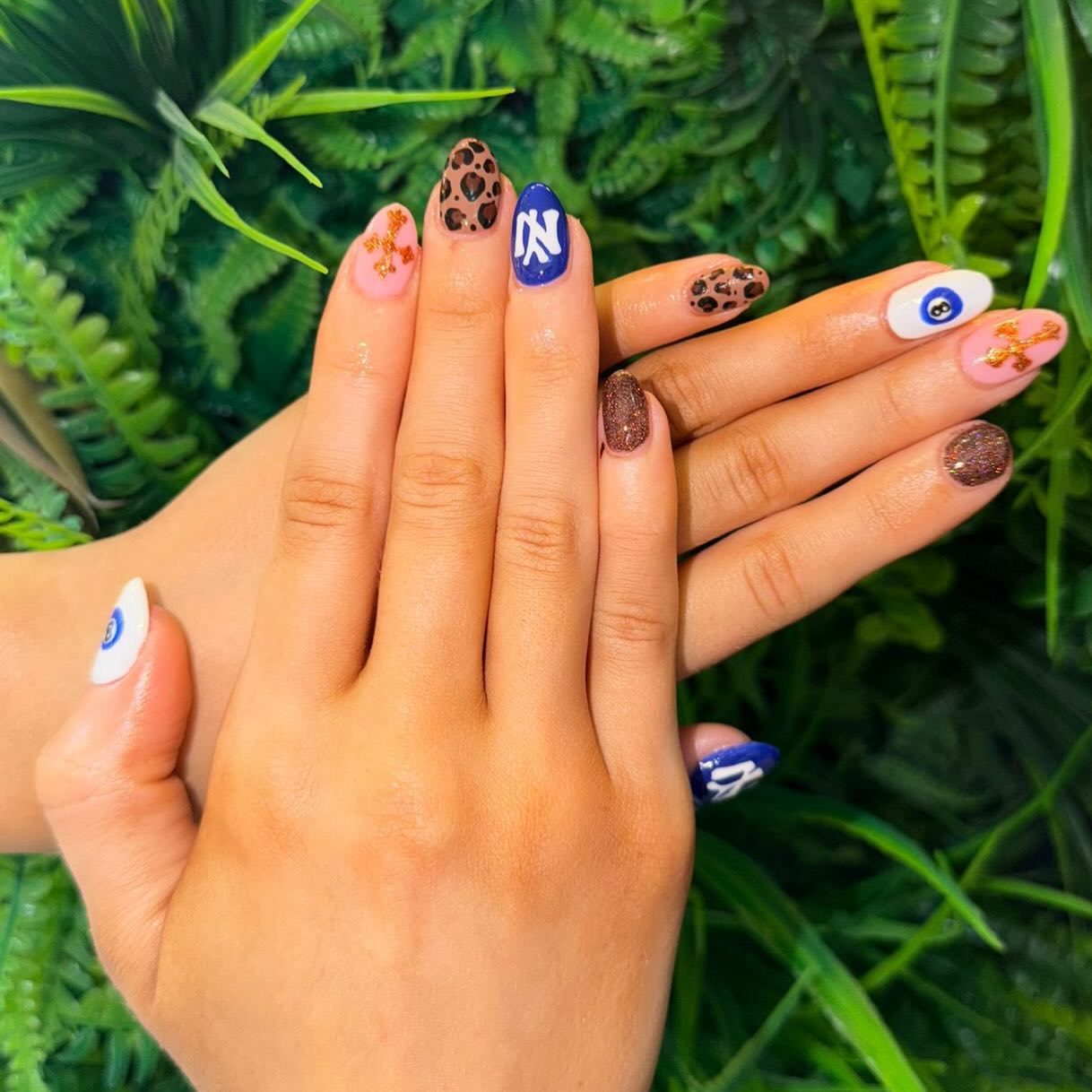 Nail game: elevated 💅✨
These custom sets by Senior Beautician Jemma are serving all the vibes — from soft pink bases with gold cross detailing, to bold navy blue accents, playful evil eye art, and fierce leopard print moments 🐆💙
Finished with a touch of glitter for that extra sparkle ✨ — because why choose one style when you can have them all?
Which design is your fave? 👀💖