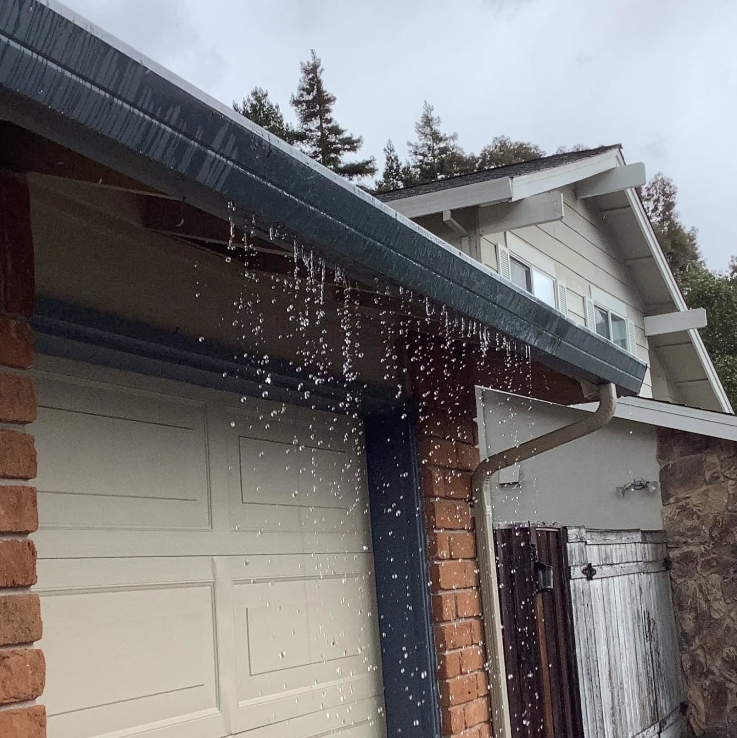 It's time for the defect of the day! Woot!!
When you inspect IN THE RAIN it makes it easy to spot problems with the roof drainage system. Here, we have an obstructed gutter that's overflowing, dumping water out in front of the garage....
Instead of being directed safely away from the structure, that water can be saturating the soil right at the foundation. Over time, this can lead to moisture intrusion, settlement, and damage to structural components. What looks like a simple maintenance issue can turn into costly repairs if not addressed.
Keeping gutters clean and ensuring proper drainage is one of the most important — and often overlooked — ways to protect a home.
If you need a gutter cleaning service, send me a message. I have an excellent service provider, and I'd be happy to make an introduction.
I hope you enjoyed today's defect of the day!!!