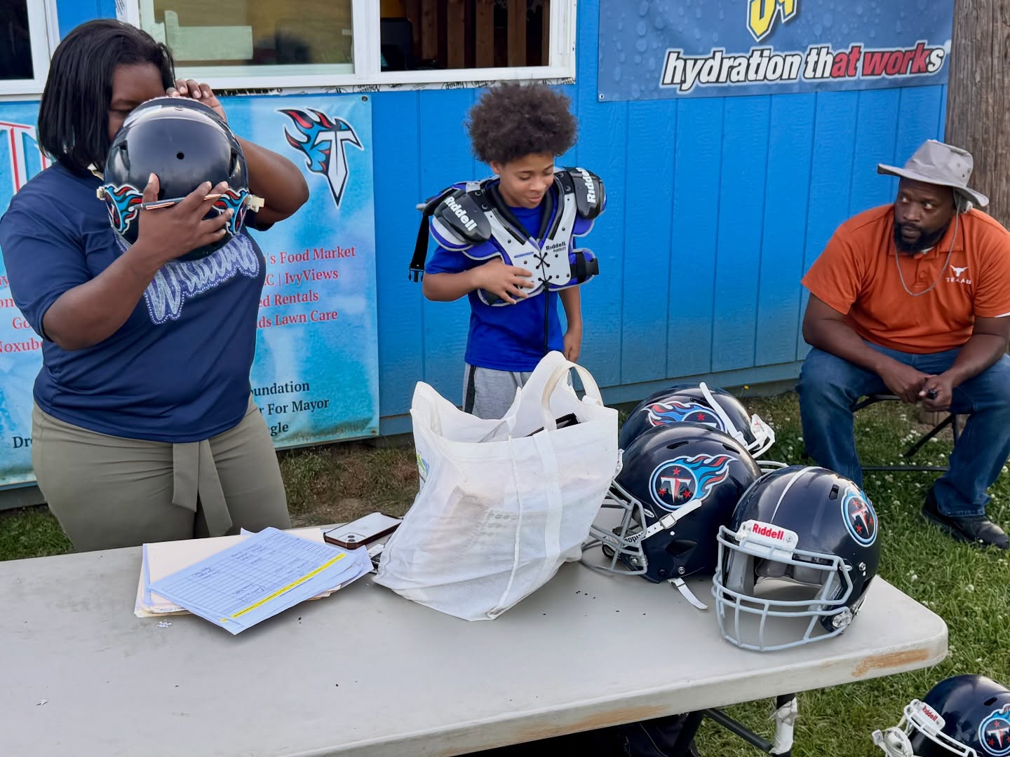12U is getting prepped with equipment. Parents came in to help, and players even arrived on bikes. Gotta love the Titans. #TitanUp #share