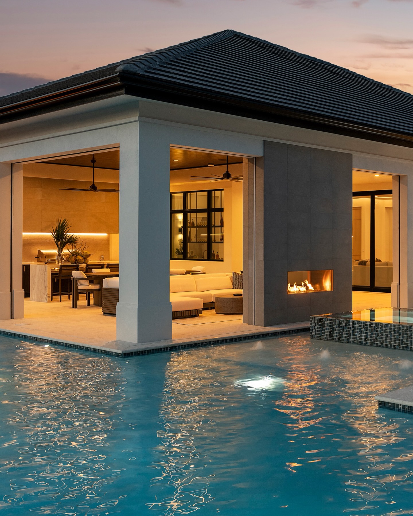 Not your typical backyard. This is a fully realized outdoor experience designed with intention at every turn.
A glassy, illuminated pool anchors the space, while the raised spa and linear fire feature create a striking focal point that carries from day into night. Under the covered lanai, the transition feels effortless. Indoor comfort spills outward, framed by clean architectural lines and a warm, ambient glow that makes the entire setting feel intimate, elevated, and undeniably livable.
At this level, it’s not about adding features. It’s about composing an environment. One that feels refined, personal, and quietly luxurious in every detail.
#LuxuryOutdoorLiving #NaplesLandscapeDesign #ModernOutdoorDesign #FloridaLiving #ResortStyleBackyard