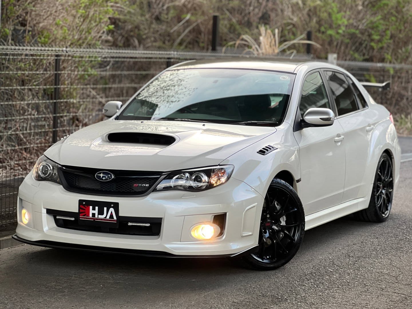 2012 Subaru Impreza WRX STI S206 NBR Challenge Package
Only 3,000km (1,864 miles) from new!
Number 78 | Auction Grade 4.5
Arriving Soon – Register Your Interest
An exceptional opportunity to acquire one of the lowest mileage examples of Subaru Tecnica International’s flagship S206 NBR Challenge Package.
With just 3,000km (1,864 miles) from new, this car sits firmly in collector-grade territory — a remarkably preserved example of one of Subaru’s rarest modern performance models.
________________________________________
Limited Production
• 300 S206 units produced worldwide
• Only 100 NBR Challenge Package cars
• Japan-market-only model
Combined with its ultra-low mileage, this example represents a particularly rare find even among S206 models.
________________________________________
NBR Challenge Package
The most desirable specification, featuring:
• Dry carbon fibre roof
• Adjustable dry carbon rear wing
• 19-inch forged BBS alloy wheels
• Nürburgring Challenge badging and interior detailing
Lightweight, purposeful, and unmistakably STI.
________________________________________
Engine & Performance
Powered by STI’s finely engineered 2.0-litre EJ20 turbocharged flat-four:
• 320 PS (316 hp)
• 431 Nm of torque
• Twin-scroll ball-bearing turbocharger
• STI-tuned ECU and sports exhaust
A highly responsive, driver-focused setup — made all the more special in such low-use, original condition.
________________________________________
Chassis & Handling
• STI-tuned Bilstein suspension
• Dedicated STI spring rates
• Flexible tower brace and draw stiffener
• Brembo braking system (6-pot front / 4-pot rear)
Delivers exceptional balance and feedback, exactly as intended.
________________________________________
Interior
• Recaro leather/Alcantara seats
• STI-specific trim and detailing
• Driver-focused cockpit with SI-Drive
The cabin presents in outstanding condition, reflecting the car’s extremely limited use.
________________________________________