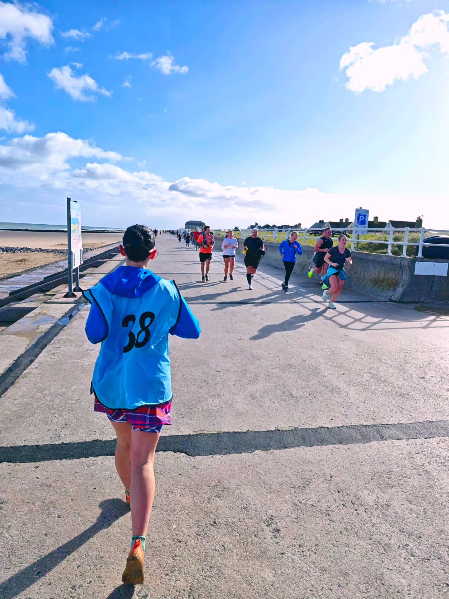 Pacer Week at parkrun… the week you get to chase the blue bibs 💙🏃♀️
…only costing you a bit of sweat 💦 and at least one lung somewhere around mile two 😅🫁
I returned to the privilege of pacing 38 minutes ⏱️
The blue bib of 3️⃣ and 8️⃣ as my brain repeatedly checked and rechecked my pacing maths every quarter mile 🤯📊, whilst joining 2️⃣8️⃣8️⃣ other parkrunners, walkers & wheelers around the Nova course along Prestatyn beach 🌊💨
A morning that started with a proper wake-up wind 🌬️ and finished with glorious sunshine ☀️
Pacing carries a quiet kind of honour 💙
It’s holding a steady rhythm when your legs want to surge.. or slow 🏃♀️
It’s listening to your breathing 😮💨, checking your watch (again ⌚), and knowing that someone, somewhere just behind you is trusting you to get it right 🙌
It’s not about your run on that day. it’s about their run 🤝
And having someone to follow? That’s everything 👣
No watch-watching every 30 seconds ⌚❌
No second guessing the pace 🤔❌
Just locking in 🔒, switching off a little 🧠➡️✨ letting your legs do the work while someone else carries the clock ⏱️
But here’s the thing about parkrun… it’s never just about the time ⏱️
It’s about the people who get up on their day off to make it all happen… ⏰➡️🏃♀️
The early alarms 🚨
The course checks 👀
The last-minute changes when the weather has other ideas 🌬️😅
The quiet commitment to bringing together a weekly event where everyone is welcome, included, and able to stand on the same start line 💛
Let's hear it for the volunteers, cheering like you’re leading the Olympics 📣🥇
The kids, sprinting off like rockets 🚀 and then mysteriously reappearing at the finish 😅
The dogs, dragging their humans round for a PB 🐕💨
The prams, being pushed with serious strength (honestly, respect 💪👶)
The mums, the dads, the grans, the grandpas 👨👩👧👦
The club runners, representing proud 🏃♂️🎽
The wheelchair users, absolutely flying 🛞⚡
And everyone else in between… each with their own reason for showing up 💫
To everyone who followed the blue bibs.. thank you for trusting the pace 💙 and for showing up.
The blue bibs will be returning to @novaprestatynparkrun very soon.. Will you?