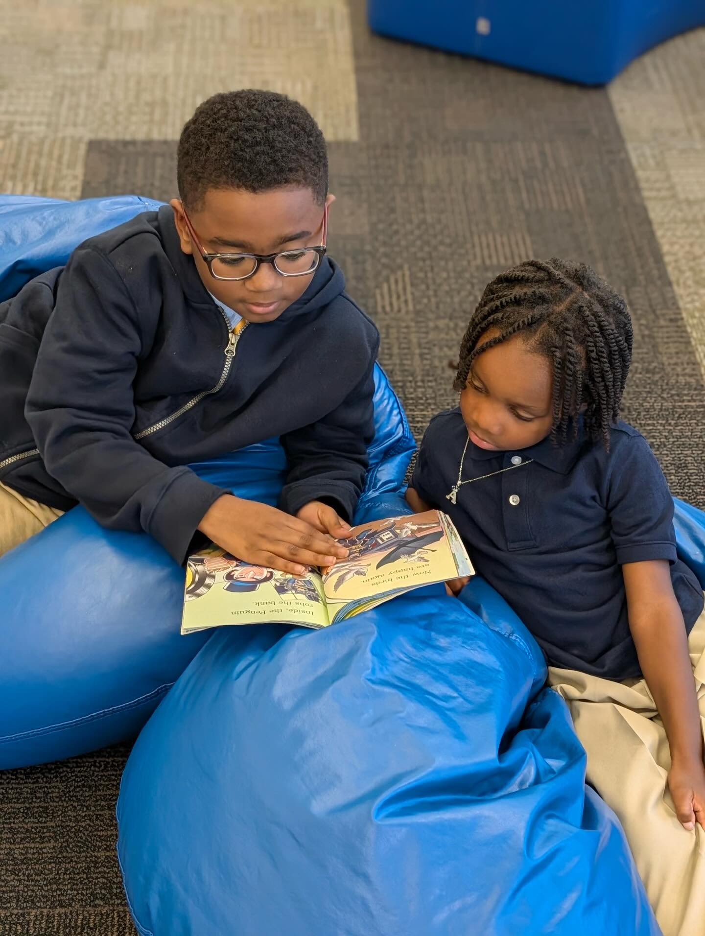 Big brothers in action.
5th graders reading with our youngest kings.