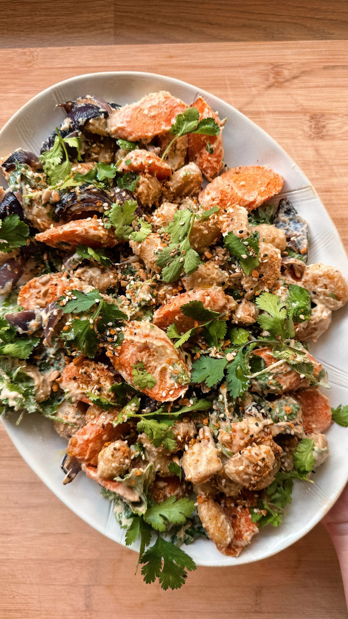 Warm Gnocchi Salads - Episode Three.
Middle Eastern Carrot and Cauliflower Gnocchi Salad 🥕
The spices in this salad dish are carried beautifully by the cauliflower gnocchi, while the lemon tahini dressing add a creamy, citrus-y kick and ties the whole thing together perfectly. Recipe from @izziemcox🌟
Serves 3
3 large carrots, peeled and cut into 2cm slices
1 red onion, cut into wedges
2 tbsp extra virgin olive oil
1 tsp ground cumin
1 tsp ground coriander
½ tsp ground cinnamon
250g Sunny & Luna Cauliflower Gnocchi
3 tbsp tahini
1 lemon, juice only
1-2 tsp agave nectar
30g coriander, leaves picked
sea salt and freshly ground black pepper
1 tbsp dukkah, to serve
Preheat the oven to 180C fan. Line a large baking tray with baking paper and add the carrots, red onion, olive oil, spices and some salt and pepper. Roast for 10 minutes.
Add the gnocchi to the tray and toss with the spiced oil, then return to the oven for 15-20 minutes until everything is golden and crisp.
Meanwhile, make the tahini dressing, add the tahini, lemon juice, honey, plenty of salt and 2 tablespoons of water to a bowl and whisk until smooth. You may need to add more water to get it to a pourable consistency. Taste and add more honey, lemon or salt if needed.
Add the roasted veg and gnocchi to a large bowl and toss with the tahini dressing and most of the coriander.
Transfer to a large platter or plate and finish with the rest of the coriander and dukkah.
Enjoy!