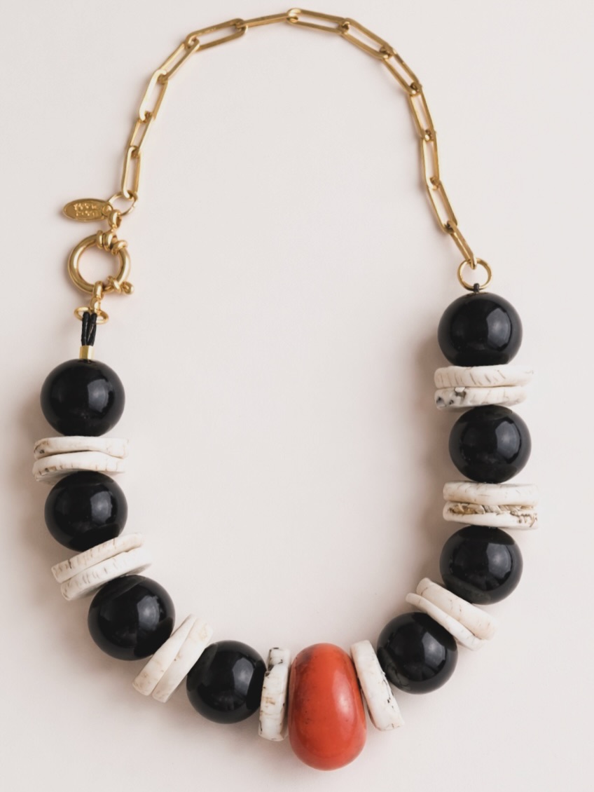 Sculptural yet effortlessly wearable, the
A M A D A Limited Edition Necklace brings together bold design and modern refinement. Glossy black beads are balanced with organic white stone discs, creating a striking interplay of texture and contrast. At the center, a luminous and unique Indian coral stone draws the eye—an understated focal point with quiet intensity.
Designed as a choker-style piece, it sits elegantly at the neckline to create a strong, sculptural silhouette. An optional extension can be added to adjust the length, offering greater versatility and allowing it to be styled slightly longer depending on the look.
Finished with a substantial gold-plated steel chain, this piece elevates everyday styling while maintaining a clean, contemporary edge. Designed to stand alone, yet versatile enough for day-to-night wear, it’s a statement in both form and function.
Produced in a limited run, the A M A D A necklace is crafted for those who appreciate distinctive design with a sense of rarity and uniqueness.
PS: Please notice that each design is slightly diffrent from one to another to bring and empower the charm of the uniqueness spirit of the limited edition pieces.