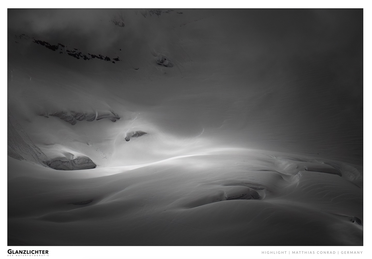 There are moments in the mountains that don’t reveal themselves immediately. They are quiet, subtle, and easy to overlook.
And yet, they often stay longer than the obvious, dramatic scenes. One of these moments has now been selected as a Highlight in the Glanzlichter 2026 Nature Photography Competition, in the category Magnificent Wilderness.
The image “Lights, Shadows, and Glaciers 001” is part of my long-term project exploring glaciers in the Swiss Alps.
What drew me to this scene was not scale or grandeur, but the way light moved across the surface of the ice. Soft transitions, gentle curves, and a quiet interplay between shadow and reflection. The glacier almost loses its physical weight. It becomes something more abstract. A landscape defined not by detail, but by light.
When we think about wilderness, we often imagine vast, dramatic views. Rugged peaks, extreme weather, powerful moments.
But for me, wilderness can also be something much quieter.
It can exist in small sections of a landscape. In subtle textures. In the way light reveals structure for just a brief moment. This photograph is part of that way of seeing.
This image is not a standalone piece. It is part of an ongoing body of work focused on glaciers, their forms, and their transformation. A process that requires time, patience, and a willingness to look beyond the obvious. And in many ways, this recognition is not an endpoint, but simply another step along that path. In the end, this photograph is less about the glacier itself, and more about how light can reshape our perception of a landscape. A reminder that even in the most powerful environments, there is space for stillness.
Congratulations to all winners and participants, and a sincere thank you to the team behind Glanzlichter for organizing and supporting this competition.